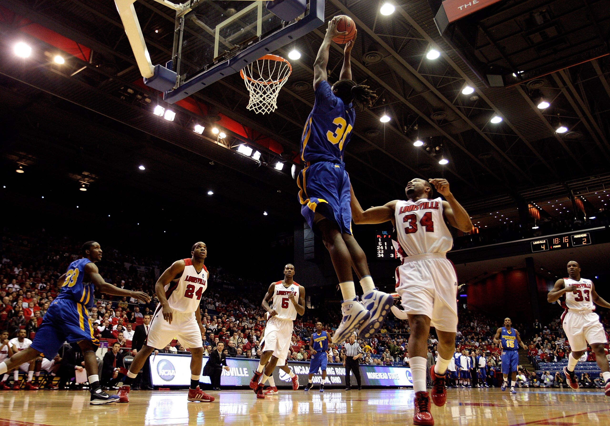 DAYTON, OH - MARCH 20: Kenneth Faried #35 of the Morehead State Eagles drives to the hoop against Jerry Smith #34 of the Louisville Cardinals during the first round of the NCAA Division I Men's Basketball Tournament at the University of Dayton Arena on Ma