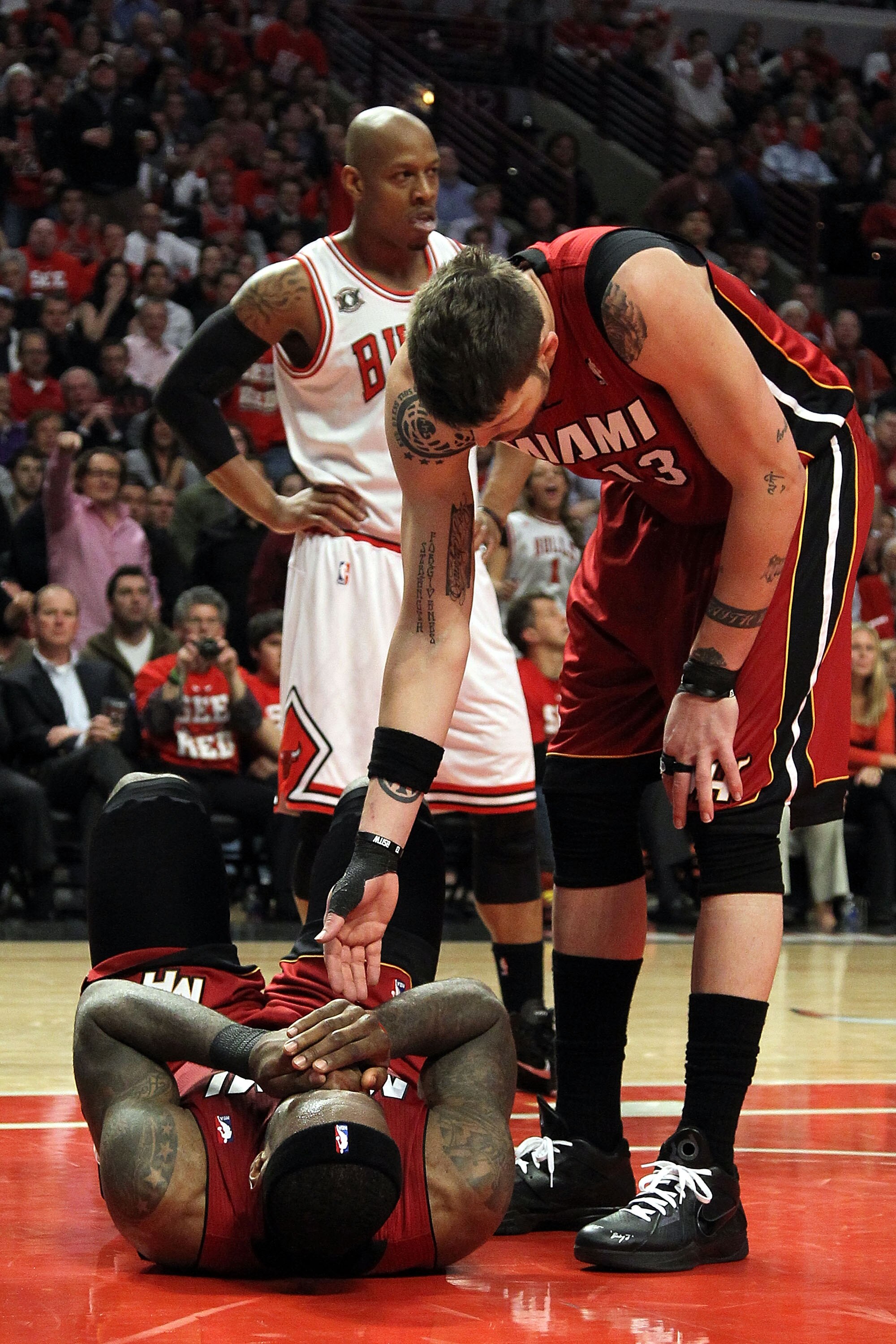 CHICAGO, IL - MAY 26:  Mike Miller #13 of the Miami Heat reaches down to help up teammate LeBron James after James was on the receiving end of a flagrant foul by Carlos Boozer #5 of the Chicago Bulls in the second half of Game Five of the Eastern Conferen