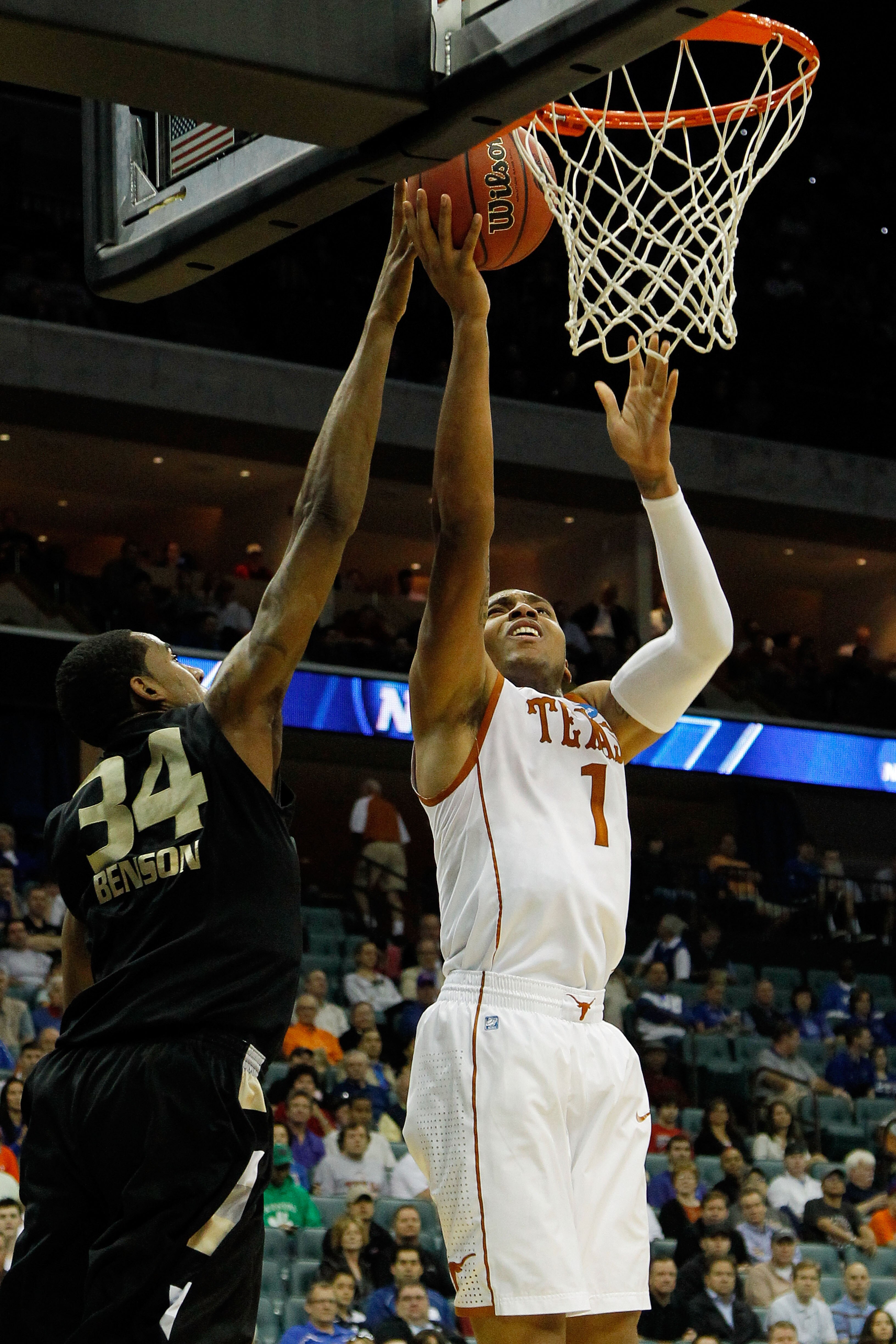 TULSA, OK - MARCH 18:  Gary Johnson #1 of the Texas Longhorns goes up for a shot as Keith Benson #34 of the Oakland Golden Grizzlies defends during the second round of the 2011 NCAA men's basketball tournament at BOK Center on March 18, 2011 in Tulsa, Okl