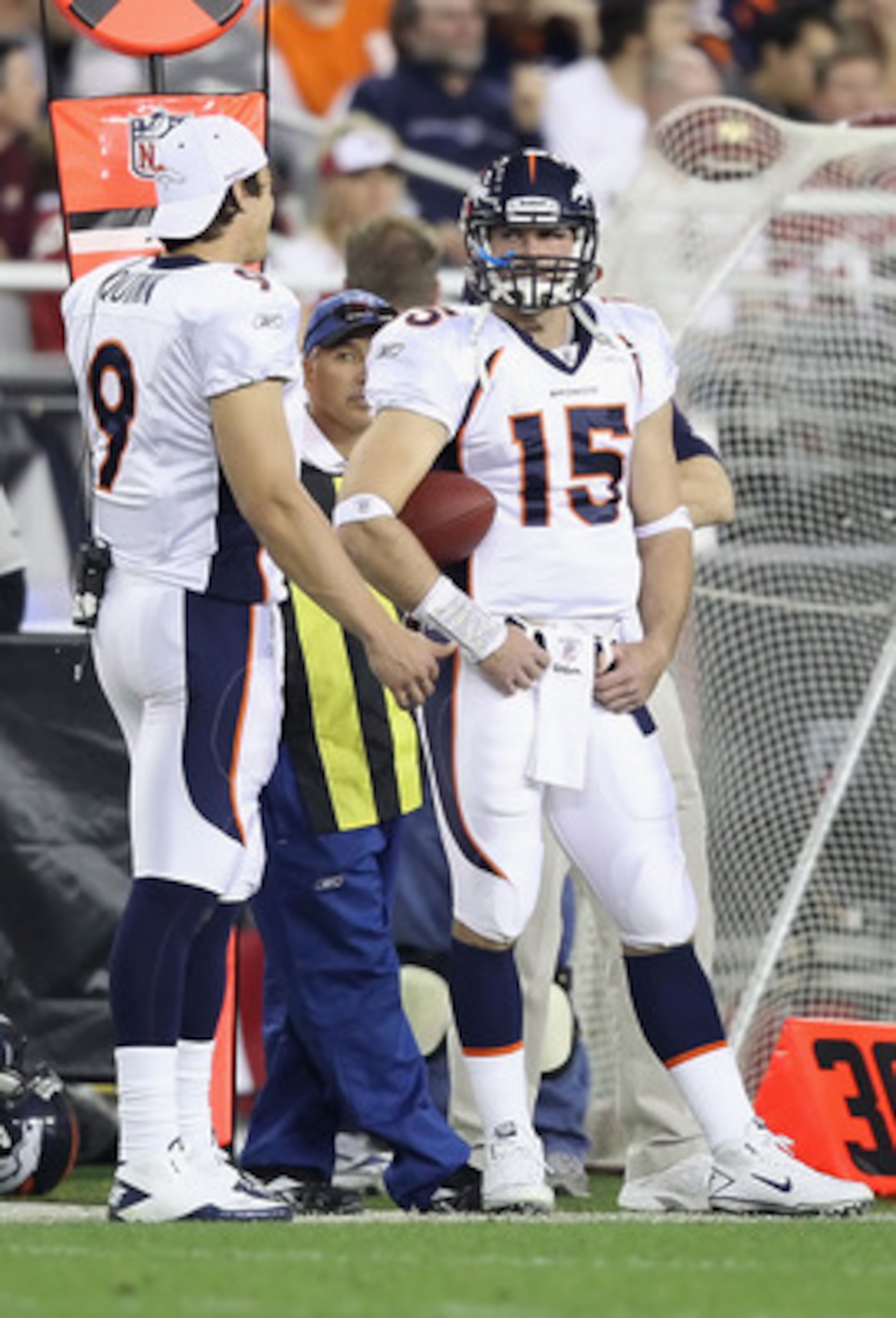 GLENDALE, AZ - DECEMBER 12: Quarterbacks Brady Quinn #9 and Tim Tebow #15 of the Denver Broncos stand on the sideline during the NFL game against the Arizona Cardinals at the University of Phoenix Stadium on December 12, 2010 in Glendale, Arizona. The GLENDALE, AZ - DECEMBER 12: Quarterbacks Brady Quinn #9 and Tim Tebow #15 of the Denver Broncos stand on the sideline during the NFL game against the Arizona Cardinals at the University of Phoenix Stadium on December 12, 2010 in Glendale, Arizona. The