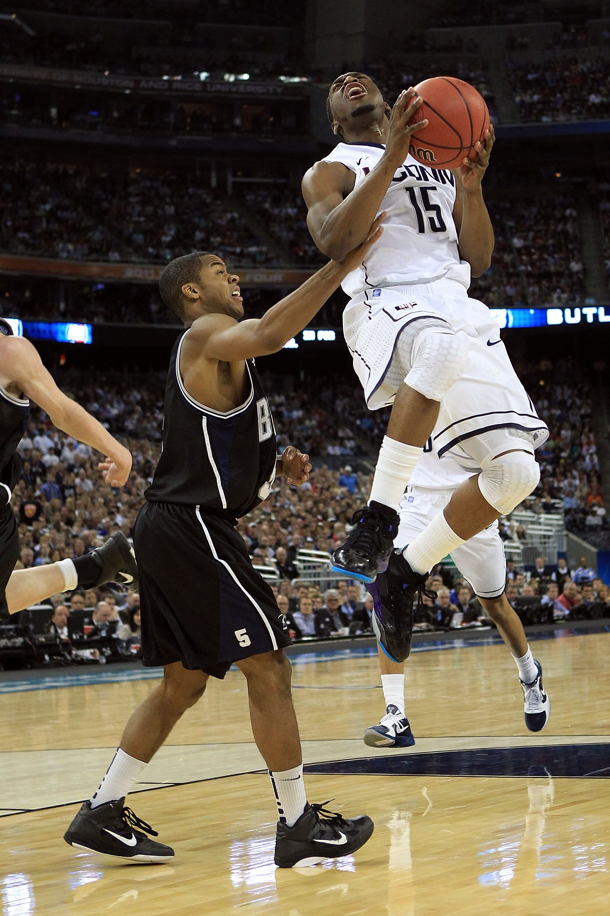 HOUSTON, TX - APRIL 04:  Kemba Walker #15 of the Connecticut Huskies goes to the basket against Ronald Nored #5 of the Butler Bulldogs during the National Championship Game of the 2011 NCAA Division I Men's Basketball Tournament at Reliant Stadium on Apri