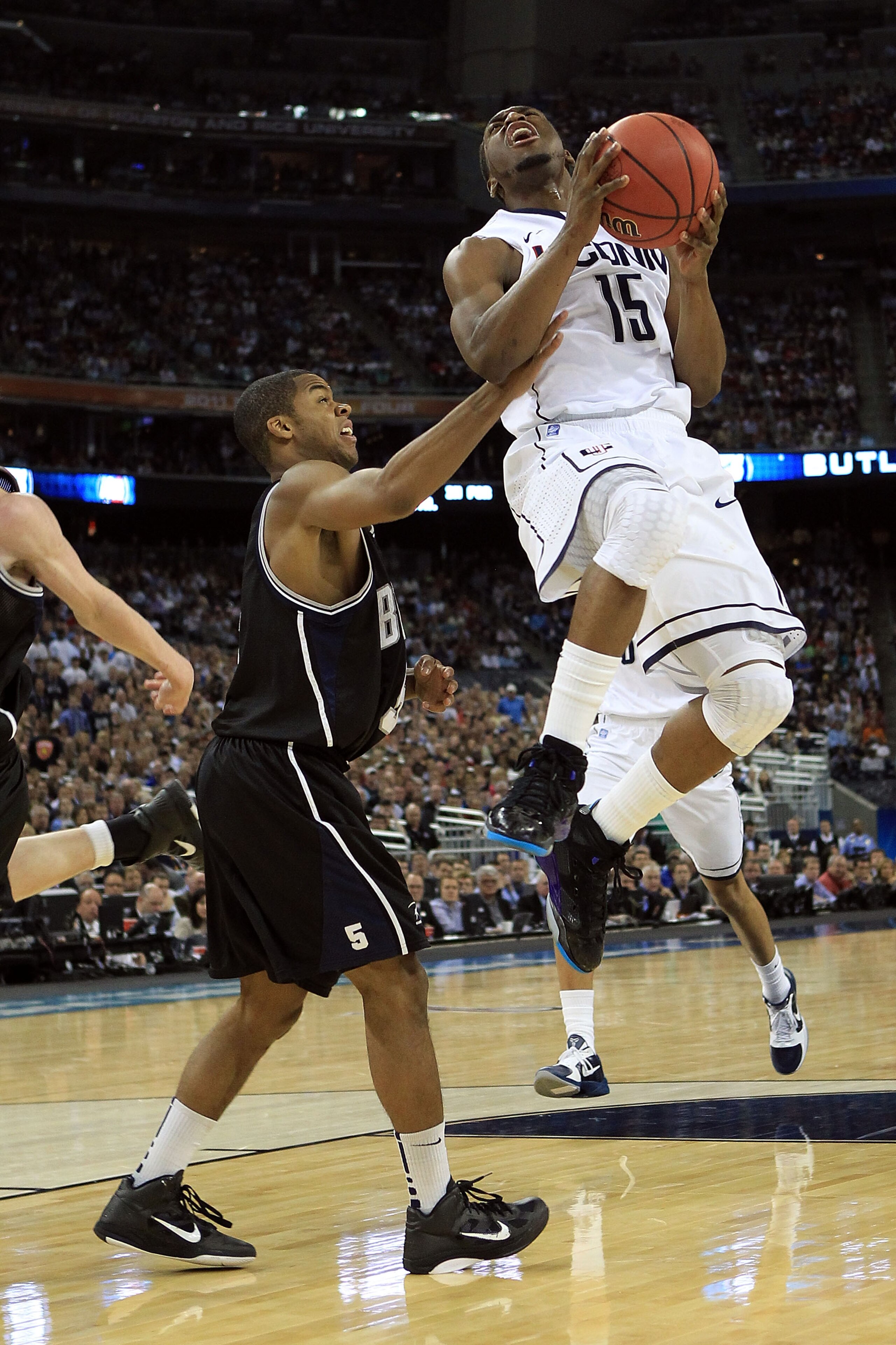 HOUSTON, TX - APRIL 04:  Kemba Walker #15 of the Connecticut Huskies goes to the basket against Ronald Nored #5 of the Butler Bulldogs during the National Championship Game of the 2011 NCAA Division I Men's Basketball Tournament at Reliant Stadium on Apri