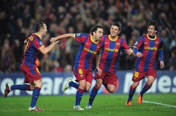 BARCELONA, SPAIN - MARCH 08:  Xavi Hernandez of Barcelona celebrates with team-mates David Villa and Andres Iniesta during the UEFA Champions League round of 16 second leg match between Barcelona and Arsenal at the Nou Camp Stadium on March 8, 2011 in Bar
