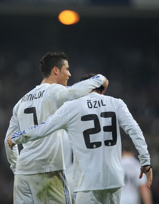 MADRID, SPAIN - JANUARY 13:  Mesut Ozil of Real Madrid celebrates with Cristiano Ronaldo after scoring Real's third goal during the Copa del Rey quarter final first leg match between Real Madrid and Atletico Madrid at Estadio Santiago Bernabeu on January