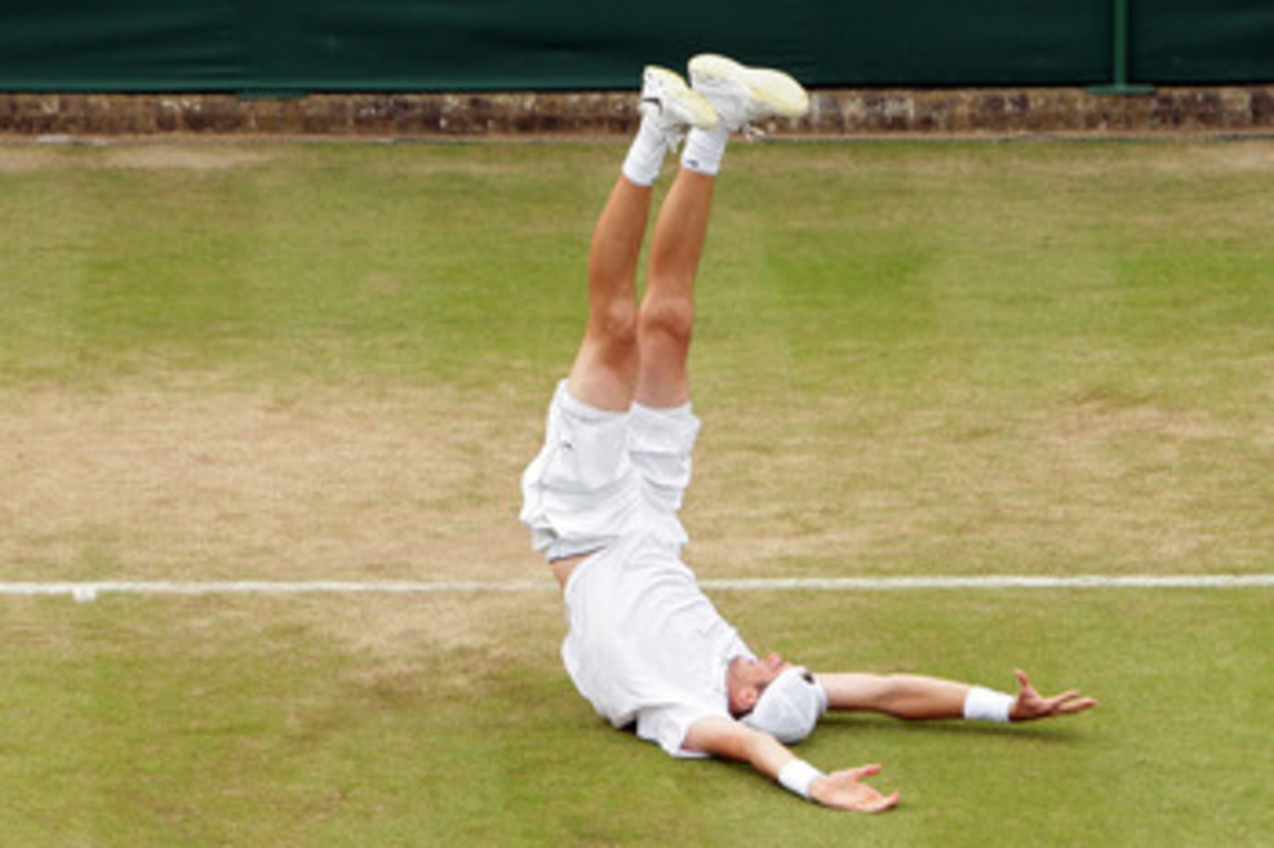 LONDON, ENGLAND - JUNE 24:  John Isner of USA celebrates winning on the third day of his first round match against Nicolas Mahut of France on Day Four of the Wimbledon Lawn Tennis Championships at the All England Lawn Tennis and Croquet Club on June 24, 2