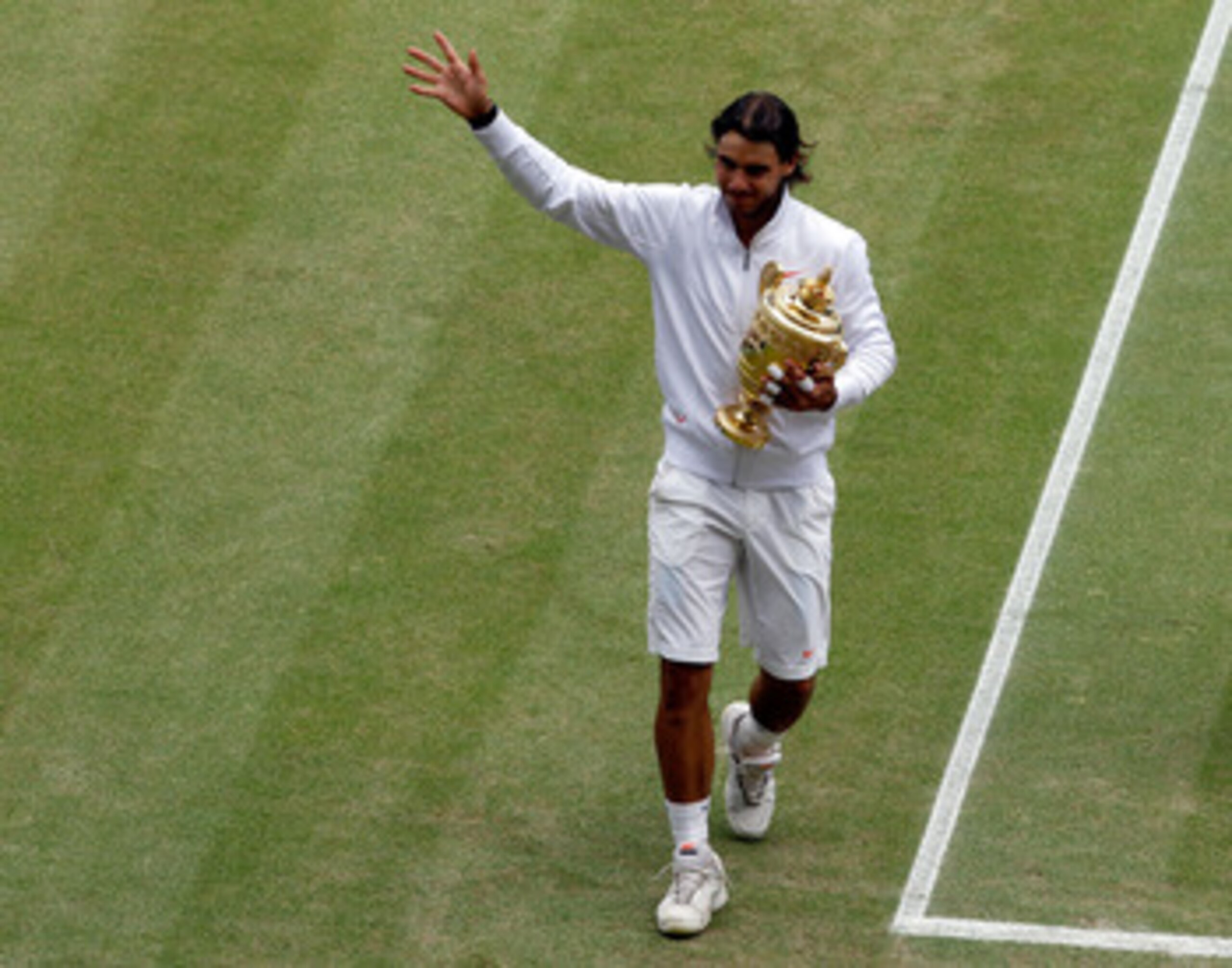 LONDON, ENGLAND - JULY 04:  Rafael Nadal of Spain lifts the Championship trophy after winning the Men's Singles Final match against Tomas Berdych of Czech Republic on Day Thirteen of the Wimbledon Lawn Tennis Championships at the All England Lawn Tennis a