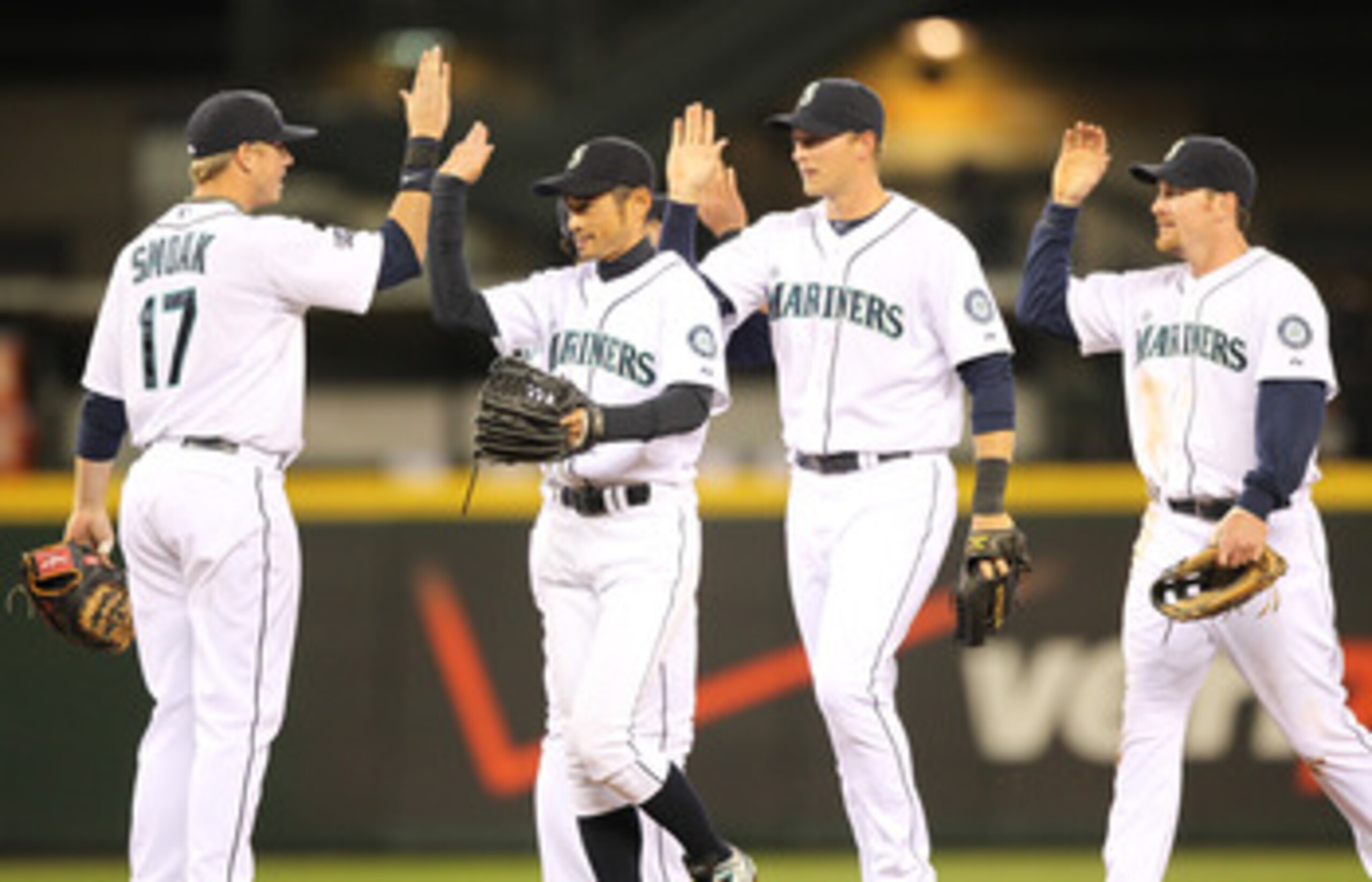 SEATTLE, WA - APRIL 12:  L to R:  Justin Smoak #17, Ichiro Suzuki #51, Michael Saunders #55, and Ryan Langerhans #12 of the Seattle Mariners celebrate after defeating the Toronto Blue Jays 3-2 at Safeco Field on April 12, 2011 in Seattle, Washington. (Pho