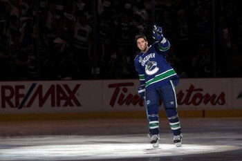 VANCOUVER, BC - JUNE 04:  Alex Burrows #14 of the Vancouver Canucks points to the crowd as he skates off the ice after scoring a goal in overtime against Zdeno Chara #33 and Tim Thomas #30 of the Boston Bruins to win Game Two of the 2011 NHL Stanley Cup F