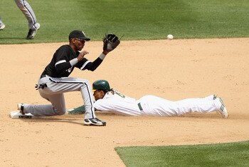 OAKLAND, CA - MAY 15:  Coco Crisp #4 of the Oakland Athletics slides safely past Alexei Ramirez #10 of the Chicago White Sox to steal second base at Oakland-Alameda County Coliseum on May 15, 2011 in Oakland, California.  (Photo by Ezra Shaw/Getty Images)
