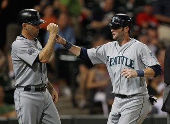CHICAGO, IL - JUNE 08: Jack Wilson #2 of the Seattle Mariners (L) congratulates teammate Adam Kennedy #4 after both scored runs in the 10th inning against the Chicago White Sox at U.S. Cellular Field on June 8, 2011 in Chicago, Illinois. The Mariners defe