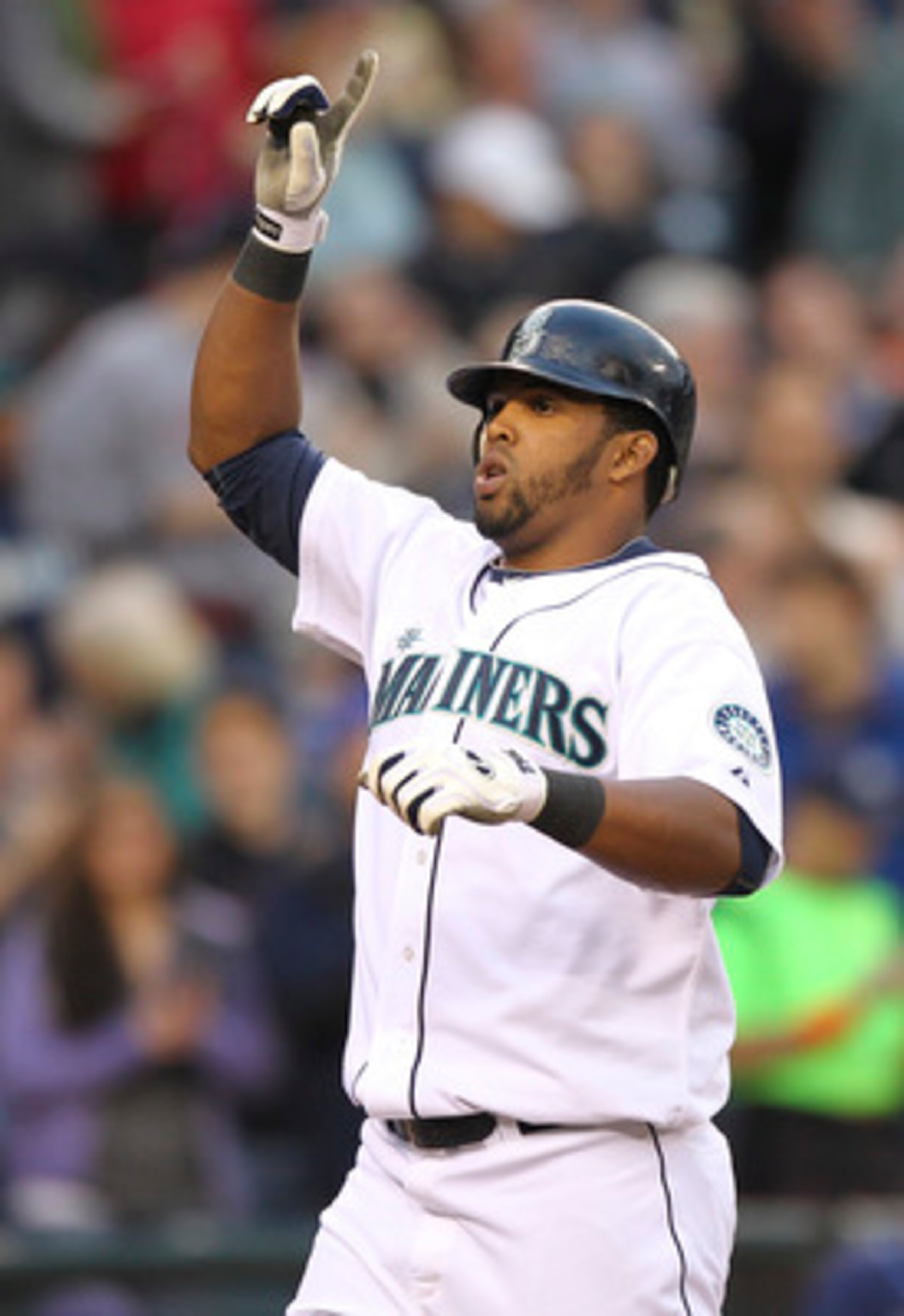 SEATTLE - JUNE 02:  Carlos Peguero #8 of the Seattle Mariners crosses home plate after hitting his second home run of the game against the Tampa Bay Rays at Safeco Field on June 2, 2011 in Seattle, Washington. (Photo by Otto Greule Jr/Getty Images)