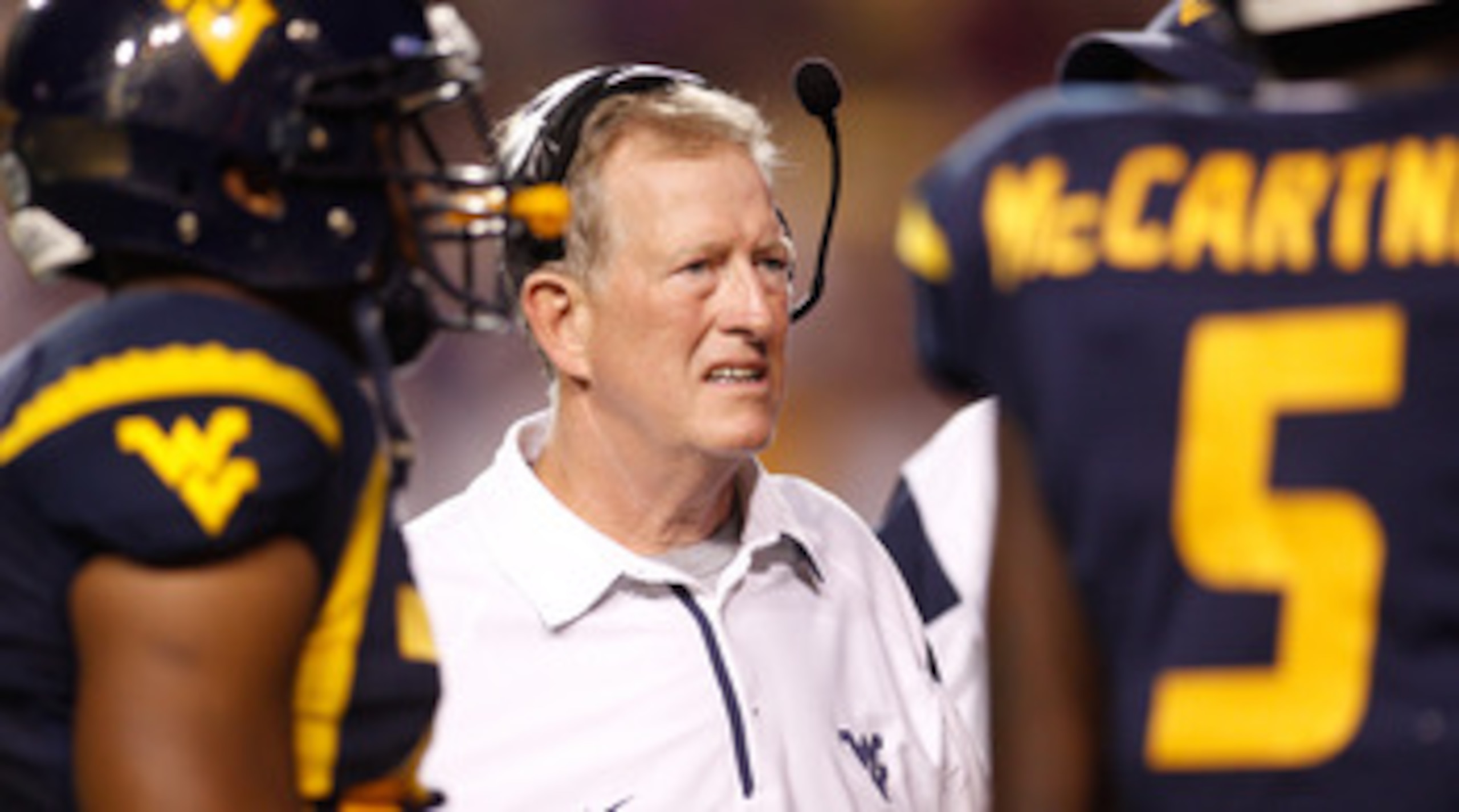 BATON ROUGE, LA - SEPTEMBER 25:  Head coach Bill Stewart of the West Virginia Mountaineers talks with his team during a timeout against the  Louisiana State University Tigers at Tiger Stadium on September 25, 2010 in Baton Rouge, Louisiana.  The Tigers de