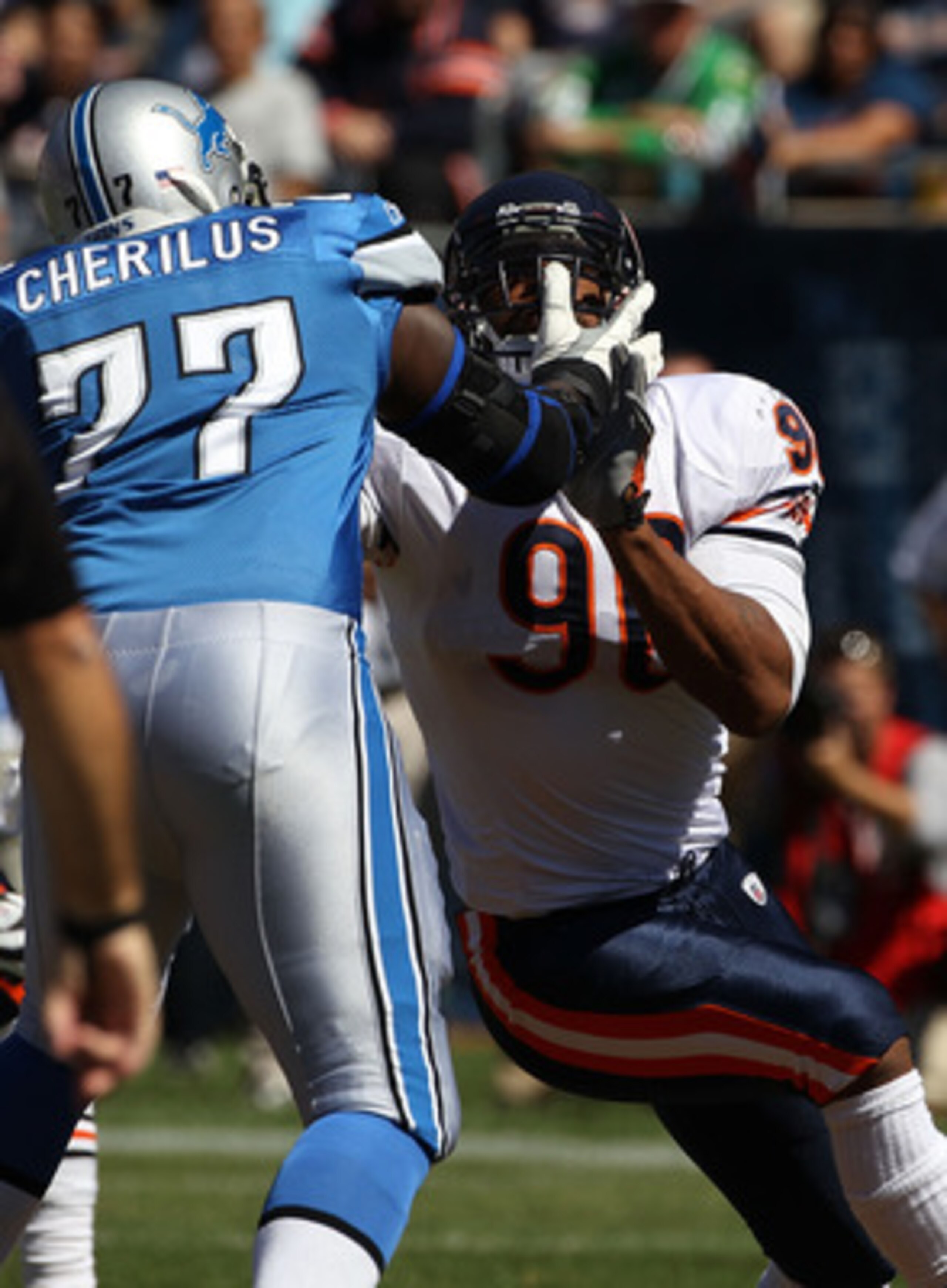 CHICAGO - SEPTEMBER 12: Gosder Cherilus #77 of the Detroit Lions gets his hands into the face of Julius Peppers #90 of the Chicago Bears during the NFL season opening game at Soldier Field on September 12, 2010 in Chicago, Illinois. The Bears defeated the