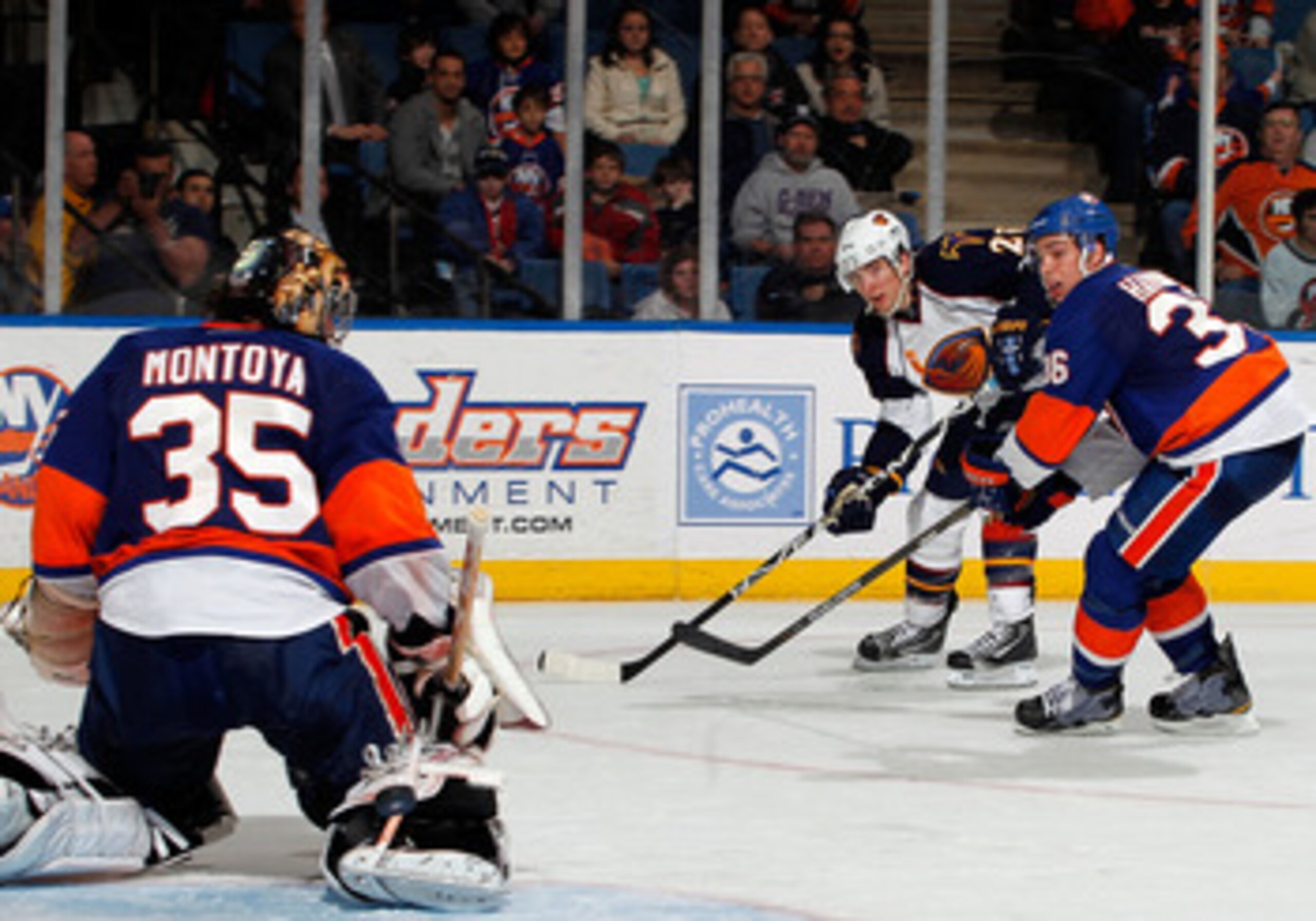 UNIONDALE, NY - MARCH 24: Blake Wheeler #26 of the Atlanta Thrashers shoots the puck as Al Montoya #35 of the New York Islanders makes the save sending the puck wide of the net and Travis Hamonic #36 of the Islanders defends during an NHL hockey game at UNIONDALE, NY - MARCH 24: Blake Wheeler #26 of the Atlanta Thrashers shoots the puck as Al Montoya #35 of the New York Islanders makes the save sending the puck wide of the net and Travis Hamonic #36 of the Islanders defends during an NHL hockey game at