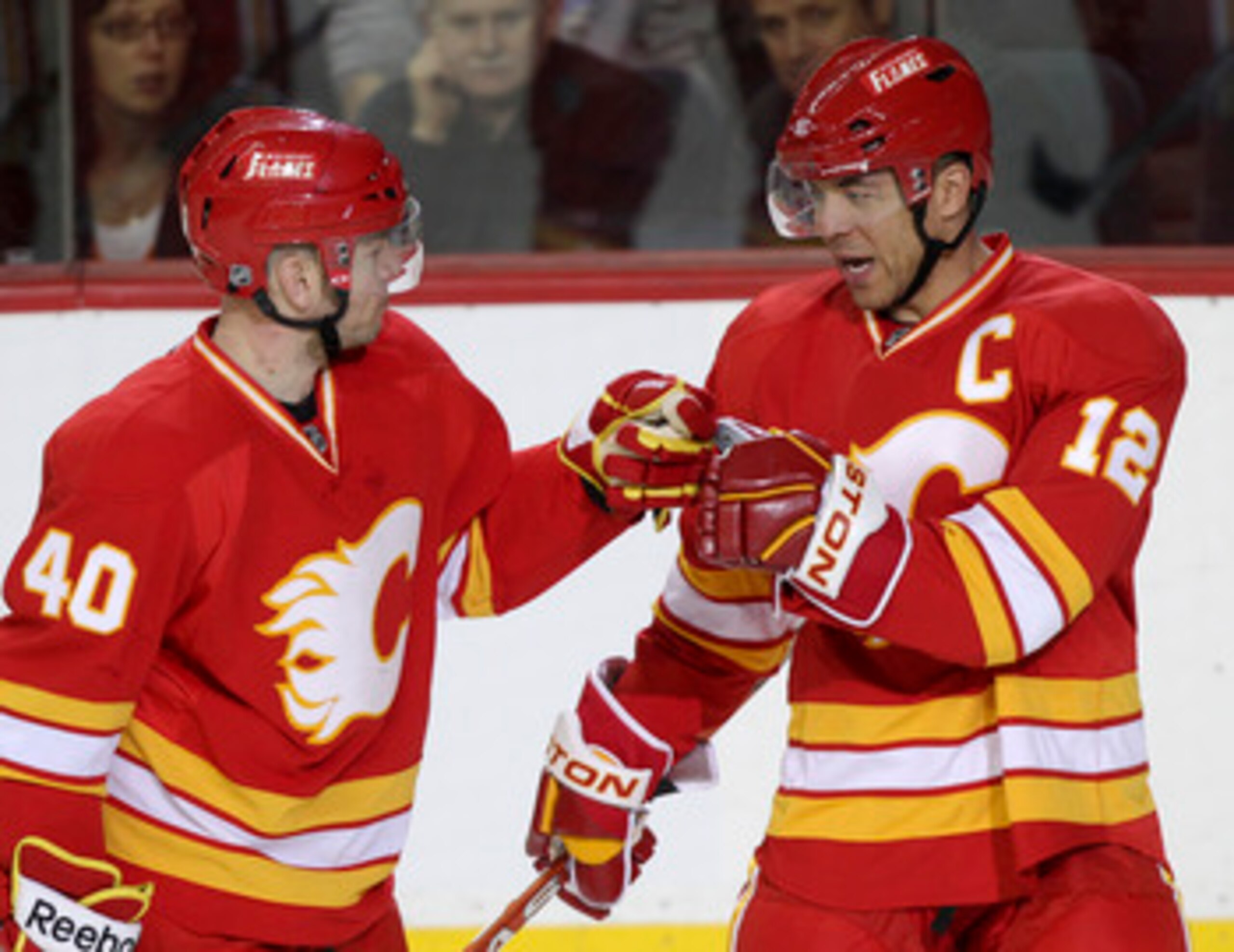 CALGARY, CANADA - APRIL 6:Jarome Iginla #12 of the Calgary Flames is congratulated by teammate Alex Tanguay #40 on his hat trick goal against the Edmonton Oilers in third period NHL action on April 6, 2011 at the Scotiabank Saddledome in Calgary, Alberta CALGARY, CANADA - APRIL 6:Jarome Iginla #12 of the Calgary Flames is congratulated by teammate Alex Tanguay #40 on his hat trick goal against the Edmonton Oilers in third period NHL action on April 6, 2011 at the Scotiabank Saddledome in Calgary, Alberta