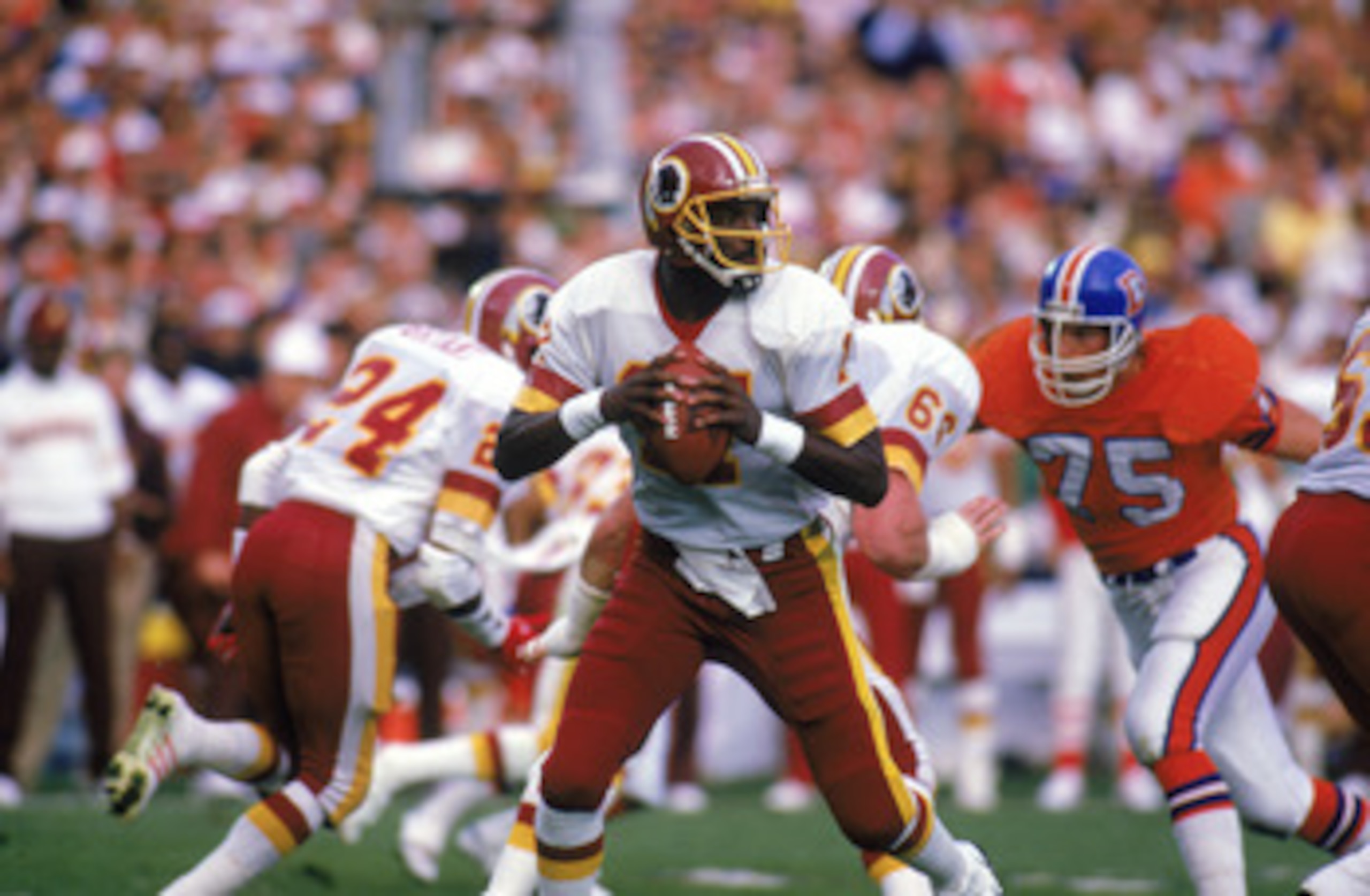 SAN DIEGO - JANUARY 31:  Quarterback Doug Williams #17 of the Washington Redskins looks to pass during Super Bowl XXII against the Denver Broncos at Jack Murphy Stadium on January 31, 1988 in San Diego, California.  The Redskins won 42-10.  (Photo by Rick