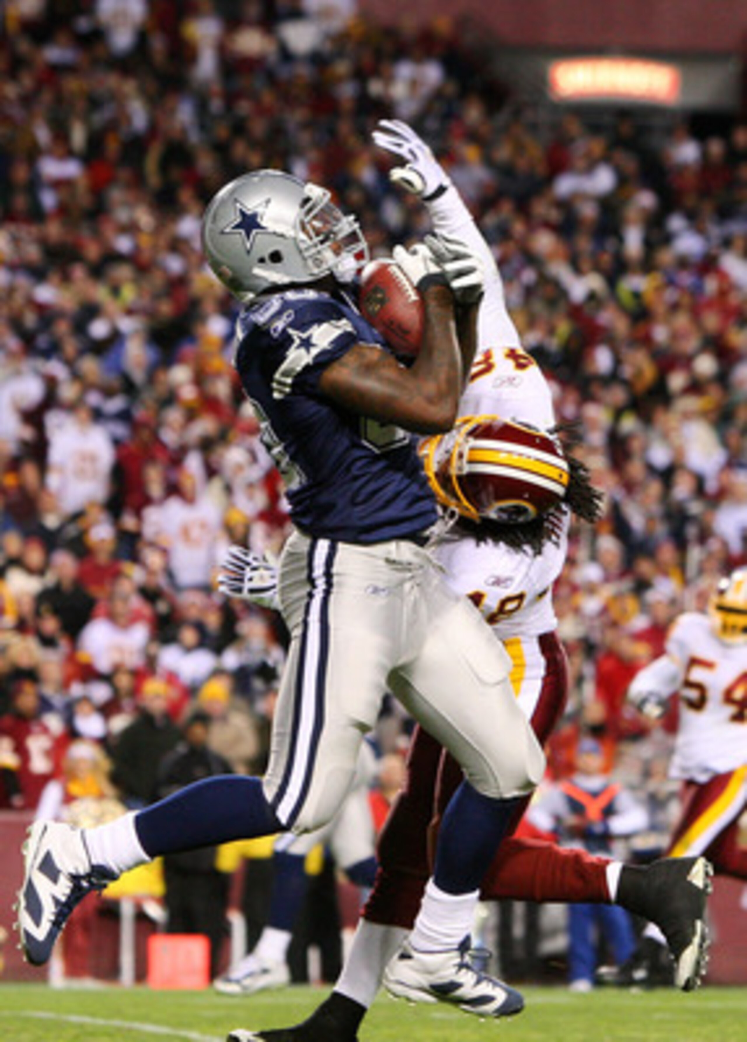 LANDOVER, MD - NOVEMBER 16:  Martellus Bennett #80 of the Dallas Cowboys catches a touchdown pass against Chris Horton #48 of the Washington Redskins to lead Dallas 14-10 over Washington in the fourth quarter during the game on November 16, 2008 at FedEx