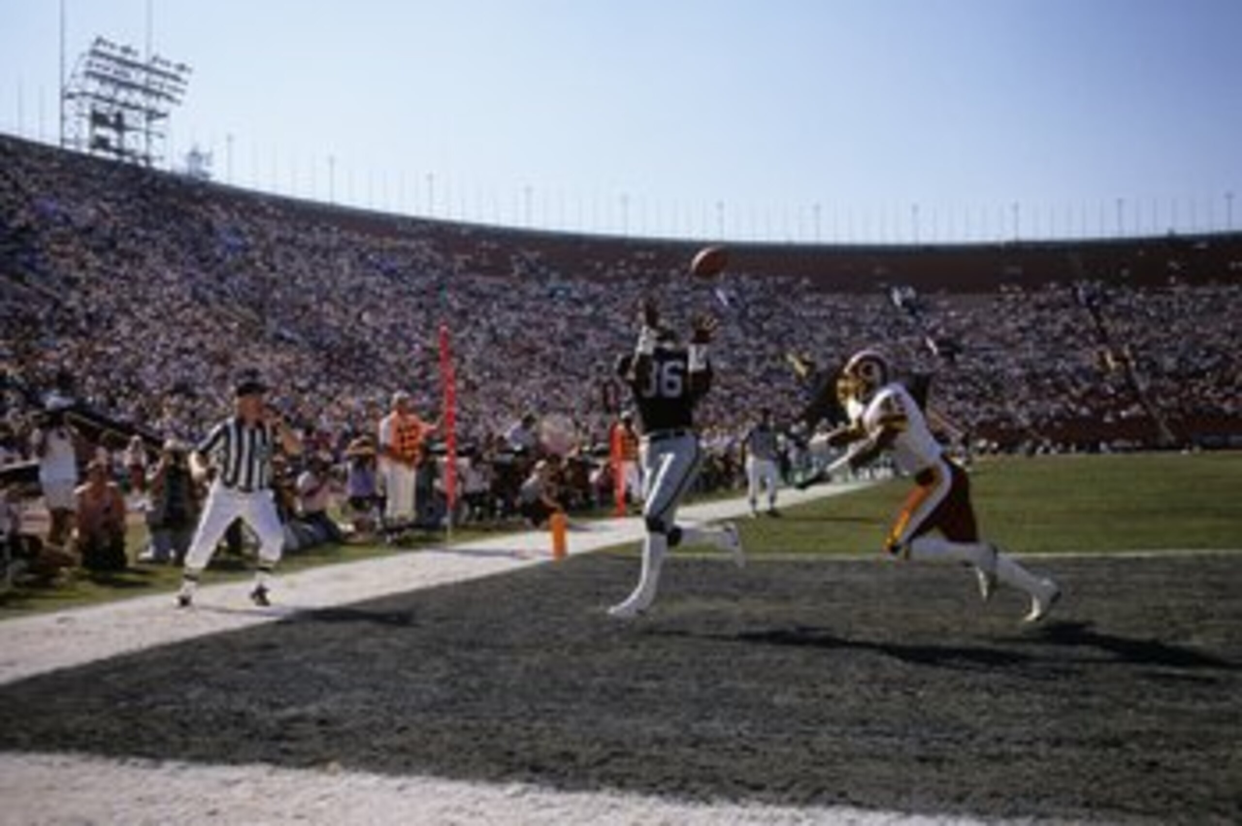 LOS ANGELES - OCTOBER 29:  Wide receiver Mervyn Fernandez #86 of the Los Angeles Raiders catches his second touchdown of the game against Washington Redskins defensive back Barry Wilburn #45 during the game at the Los Angeles Memorial Coliseum on October