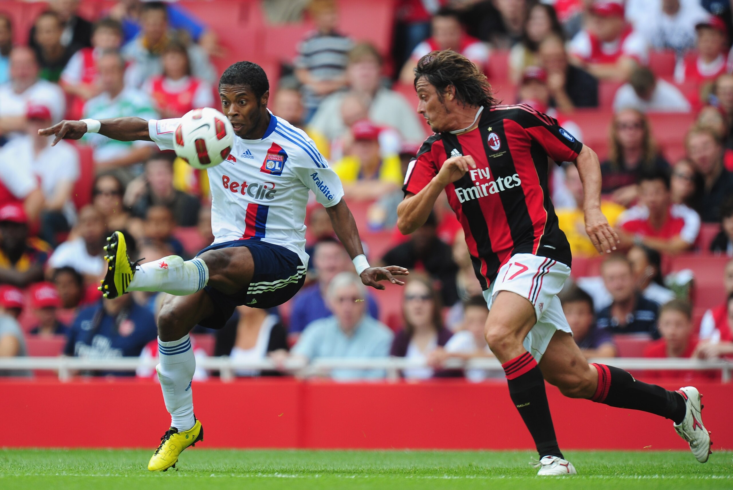 LONDON, ENGLAND - AUGUST 01:  Michel Bastos of Lyon is challenged by Massimo Oddo (R) of AC Milan during the Emirates Cup match between AC Milan and Lyon at Emirates Stadium on August 1, 2010 in London, England.  (Photo by Mike Hewitt/Getty Images)