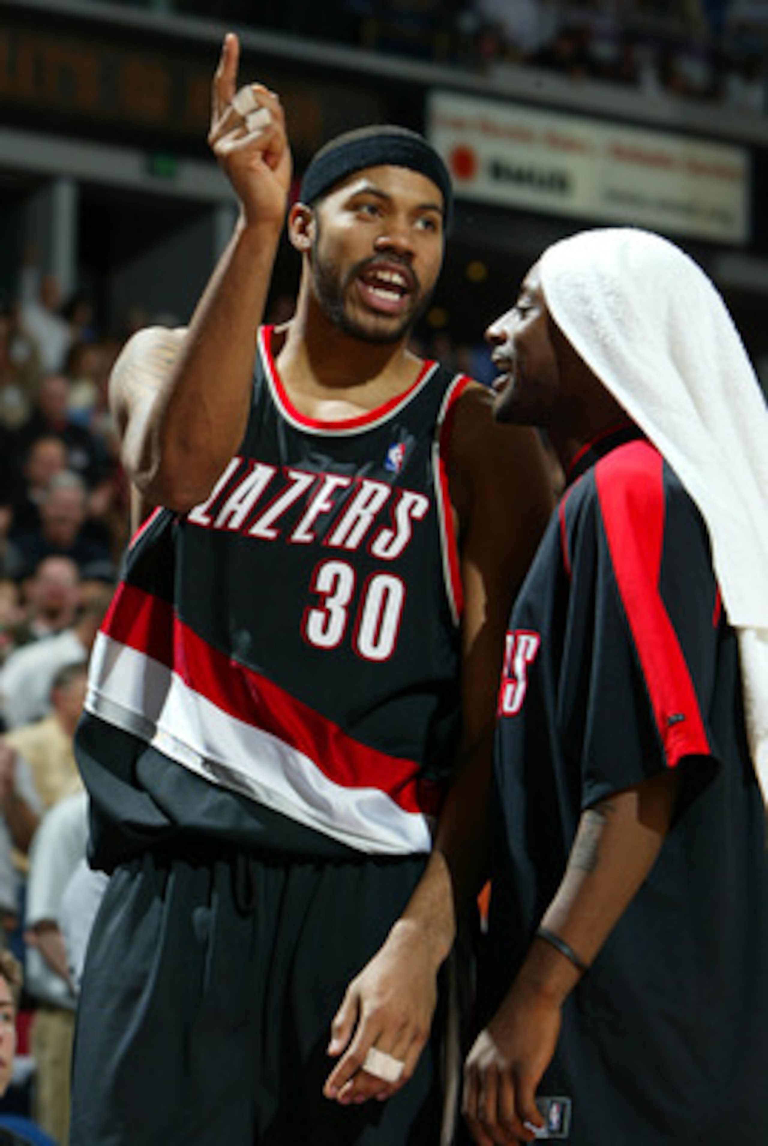 SACRAMENTO, CA -  JANUARY 20:   Rasheed Wallace #30 of the Portland Trail Blazers argues after receiving a technical foul as he is held back by teammate Jeff McInnis #5 against the Sacramento Kings during an NBA game on January 20, 2004 at Arco Arena in S