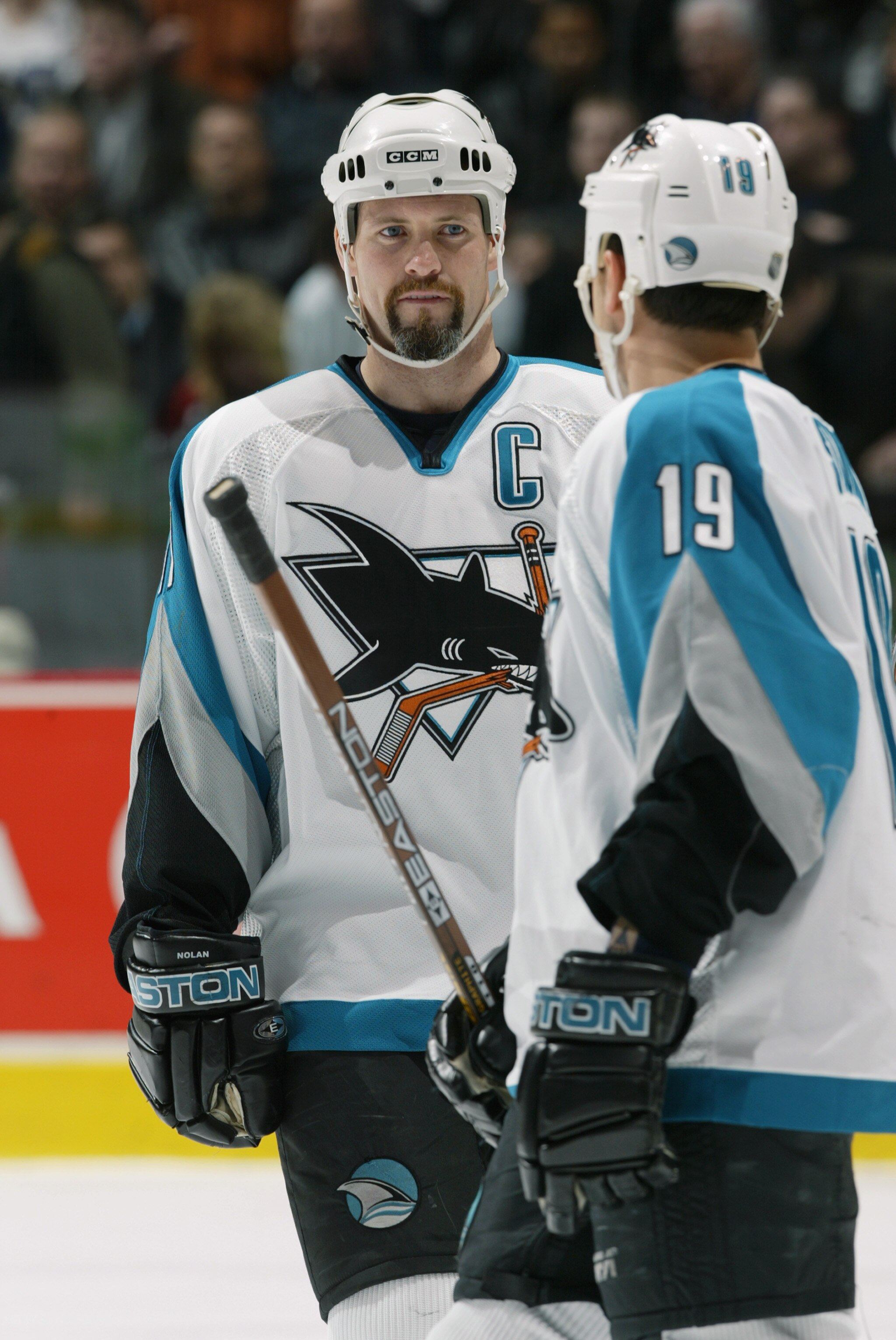 VANCOUVER - FEBRUARY 27:  Owen Nolan #11 of the San Jose Sharks talks with teammate Marco Sturm #19 during the NHL game against the Vancouver Canucks at General Motors Place on February 27, 2003 in Vancouver, Canada.  The Sharks won 3-2 .  (Photo by Jeff