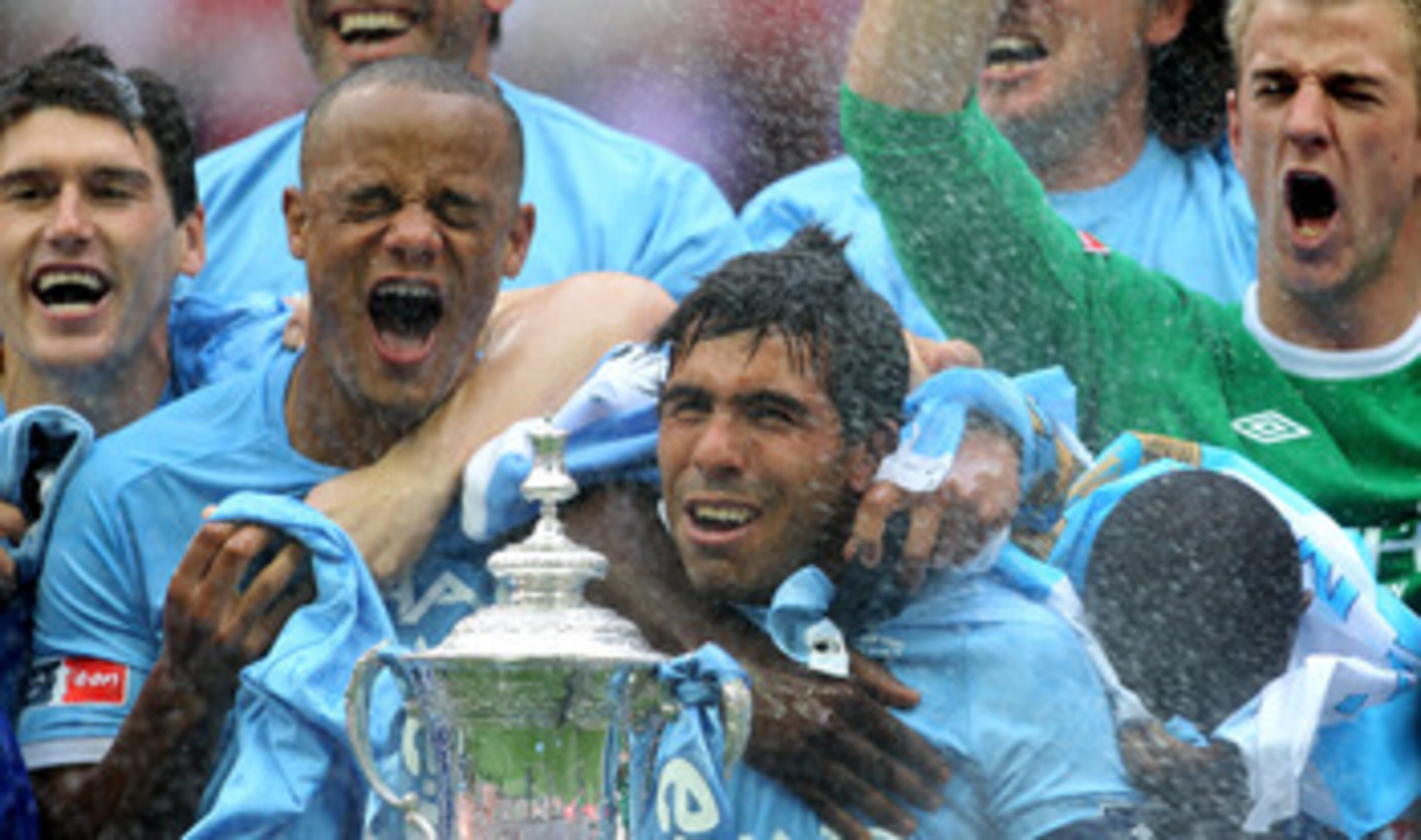 LONDON, ENGLAND - MAY 14:  Carlos Tevez of Manchester City and his team mates celebrate with the trophy after they won the FA Cup sponsored by E.ON Final match between Manchester City and Stoke City at Wembley Stadium on May 14, 2011 in London, England.