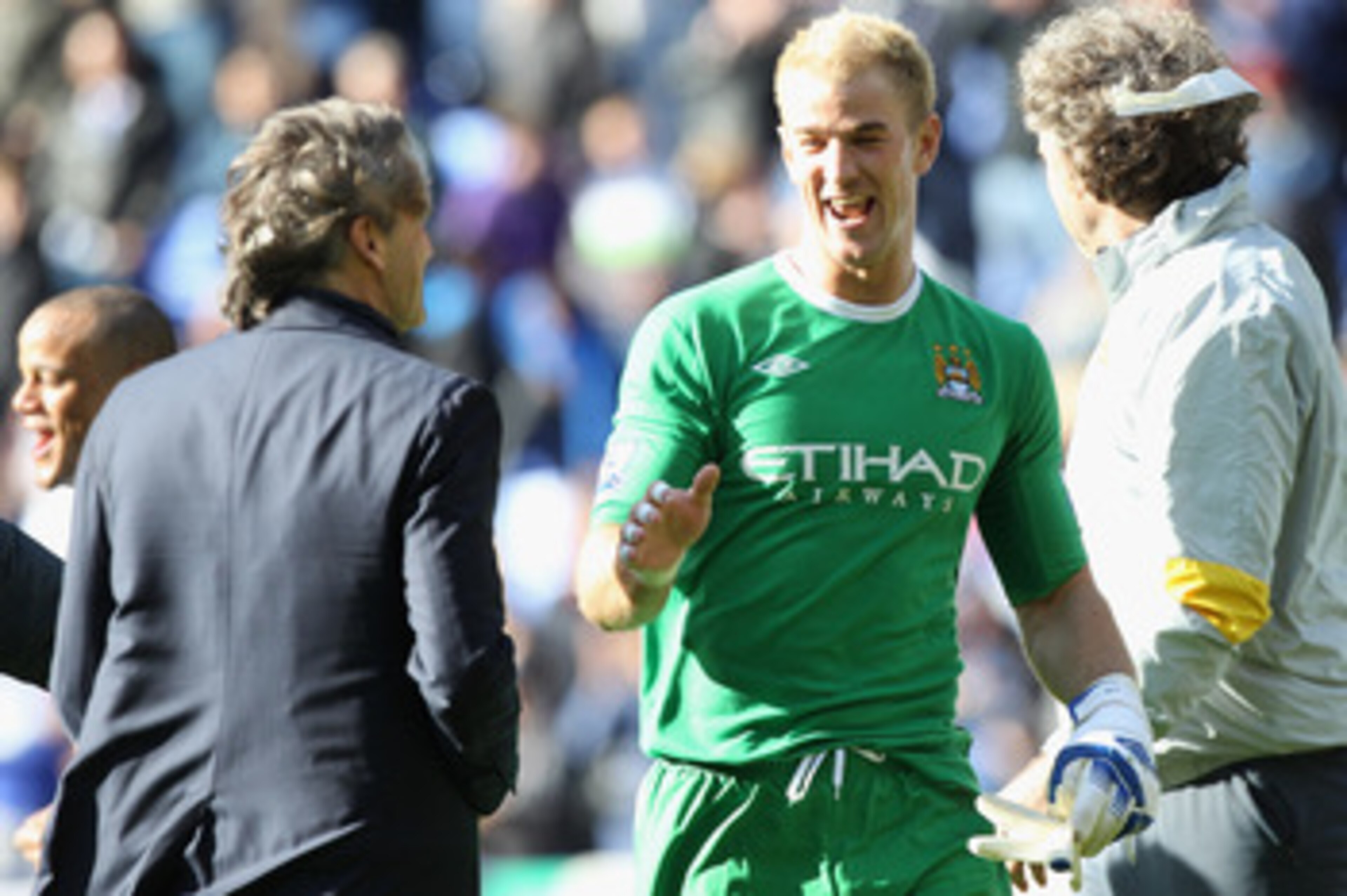 BOLTON, ENGLAND - MAY 22: Joe Hart (C) of Manchester City enjoys his sides 2-0 victory with manager Roberto Mancini (L) during the Barclays Premier League match between  Bolton Wanderers and Manchester City at the Reebok Stadium on May 22, 2011 in Bolton,