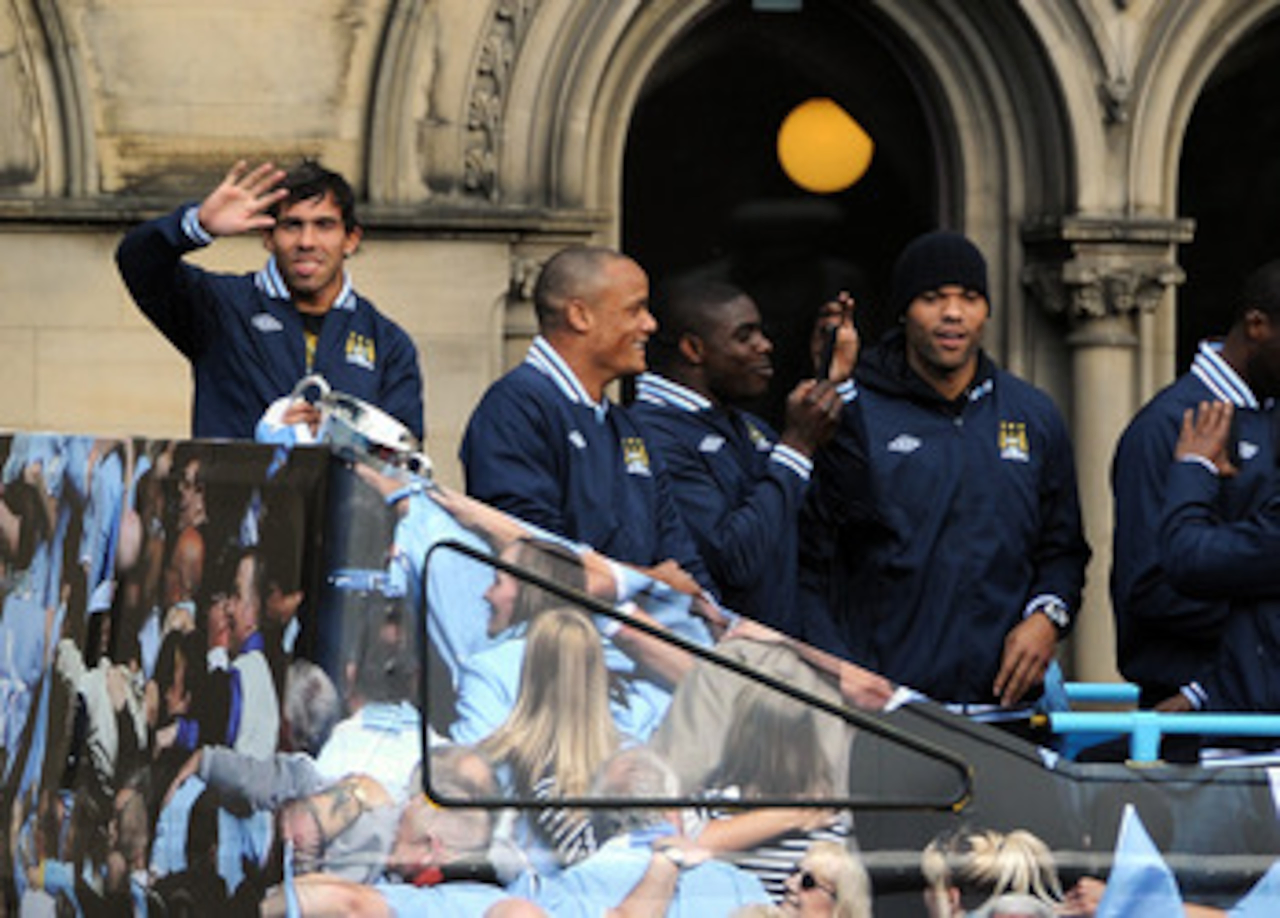 MANCHESTER, ENGLAND - MAY 23:  Carlos Tevez (L) of Manchester City waves to the crowd during the Manchester City FA Cup Winners Parade at Manchester Town Hall on May 23, 2011 in Manchester, United Kingdom.  (Photo by Chris Brunskill/Getty Images)