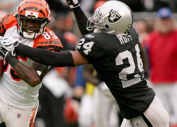 OAKLAND, CA - NOVEMBER 22:  Chad Ochocinco #85 of the Cincinnati Bengals is tackled by Michael Huff #24 of the Oakland Raiders at Oakland-Alameda County Coliseum on November 22, 2009 in Oakland, California.  (Photo by Ezra Shaw/Getty Images)