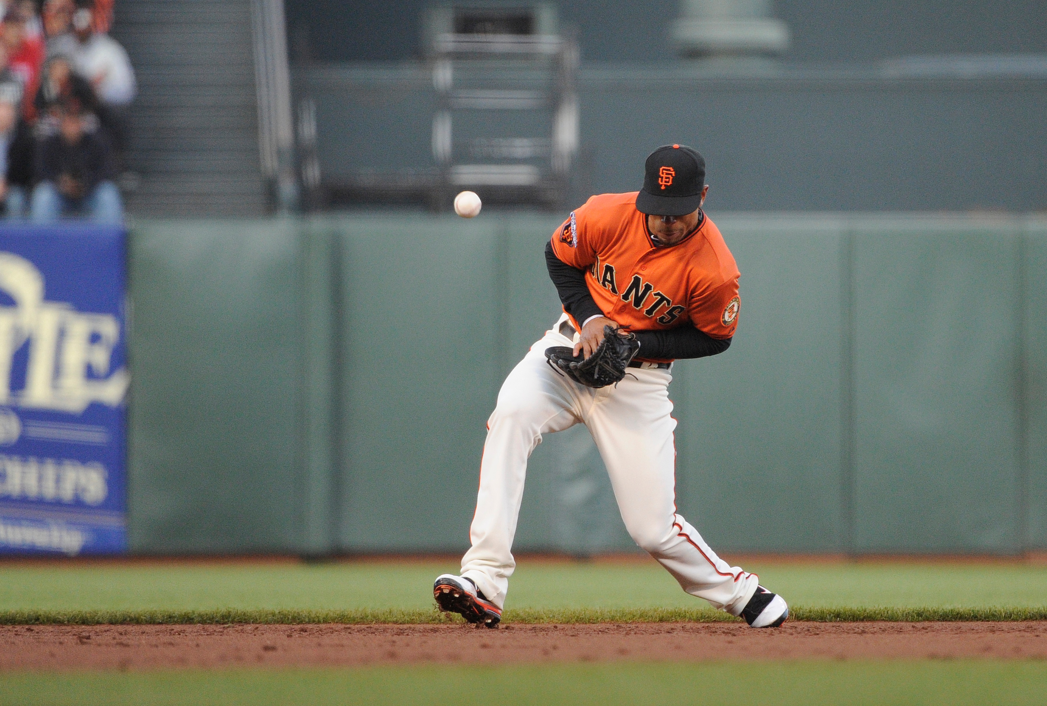 SAN FRANCISCO, CA - June 10: Shortstop Emmanuel Burriss #2 of the San Francisco Giants has the ball kick off the back of his glove for an error during a MLB baseball game against the Cincinnati Reds June 10, 2011 at AT&T Park in San Francisco, California.