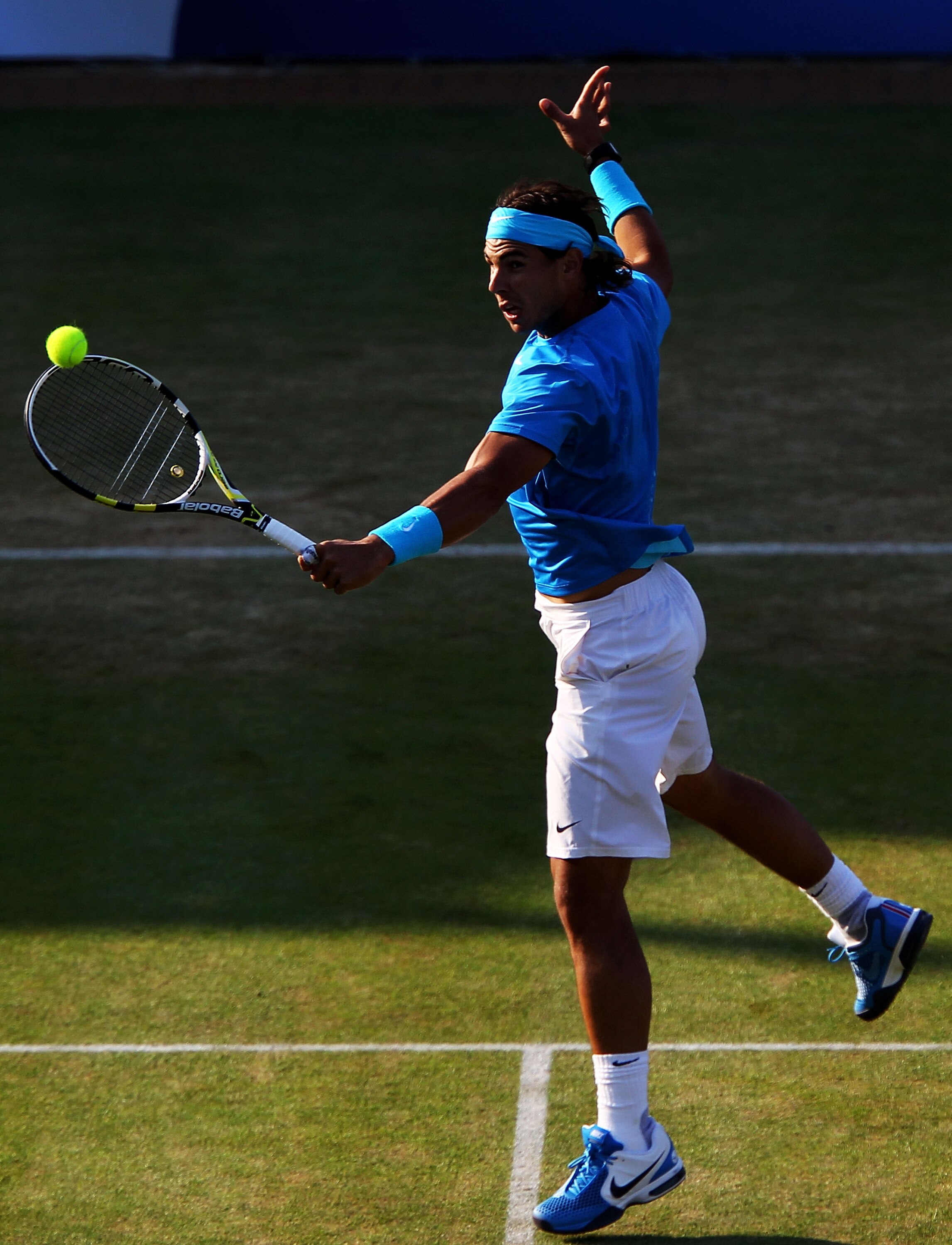 LONDON, ENGLAND - JUNE 10:  Rafael Nadal of Spain returns a shot during his Men's Singles quarter final match against Jo-Wilfred Tsonga of France on day five of the AEGON Championships at Queens Club on June 10, 2011 in London, England.  (Photo by Clive B