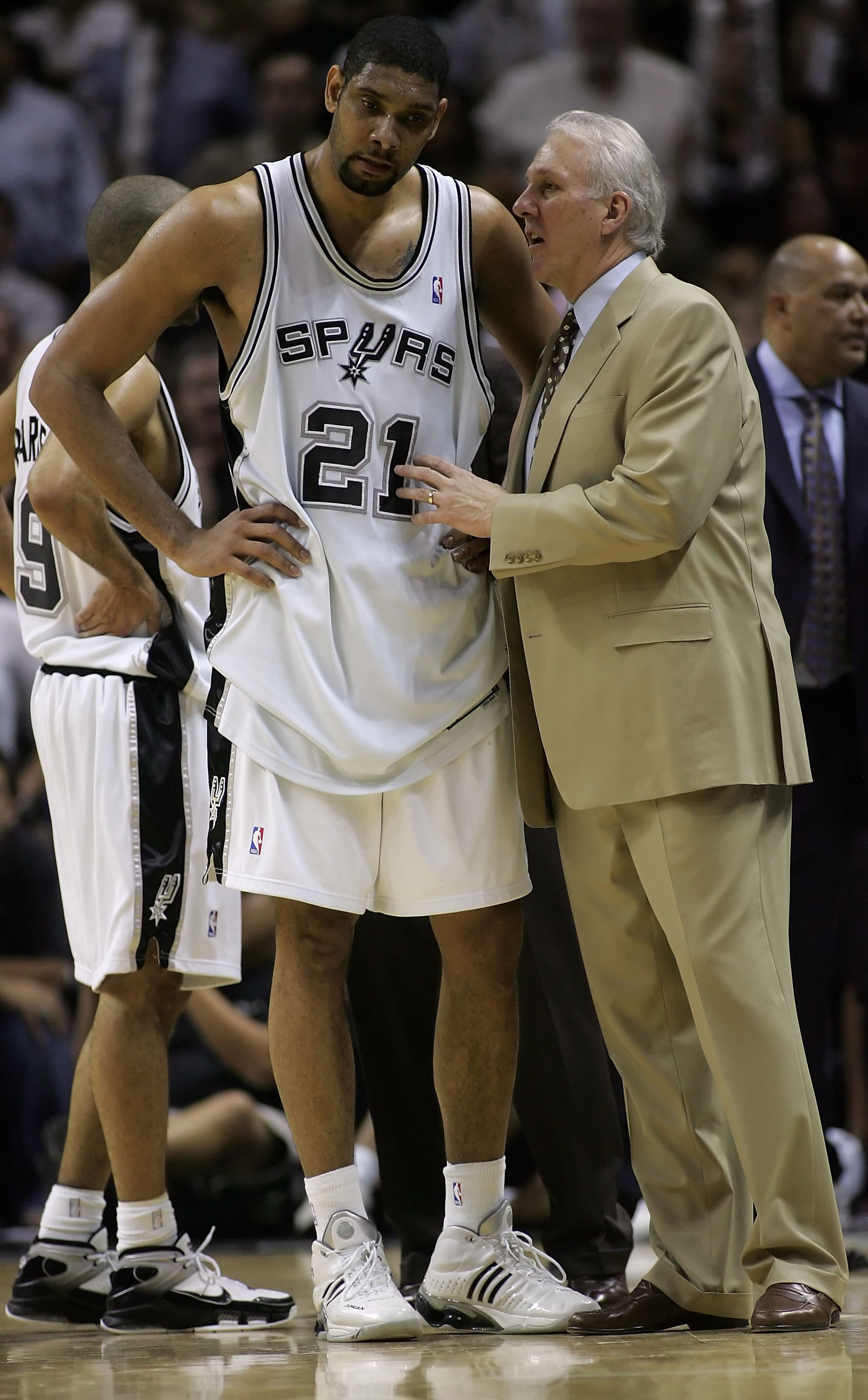SAN ANTONIO - MAY 17:  Head coach Gregg Popovich of the San Antonio Spurs talks with Tim Duncan #21 during a timeout late in the fourth quarter against the Dallas Mavericks in Game Five of the Western Conference Semifinals during the 2006 NBA Playoffs May