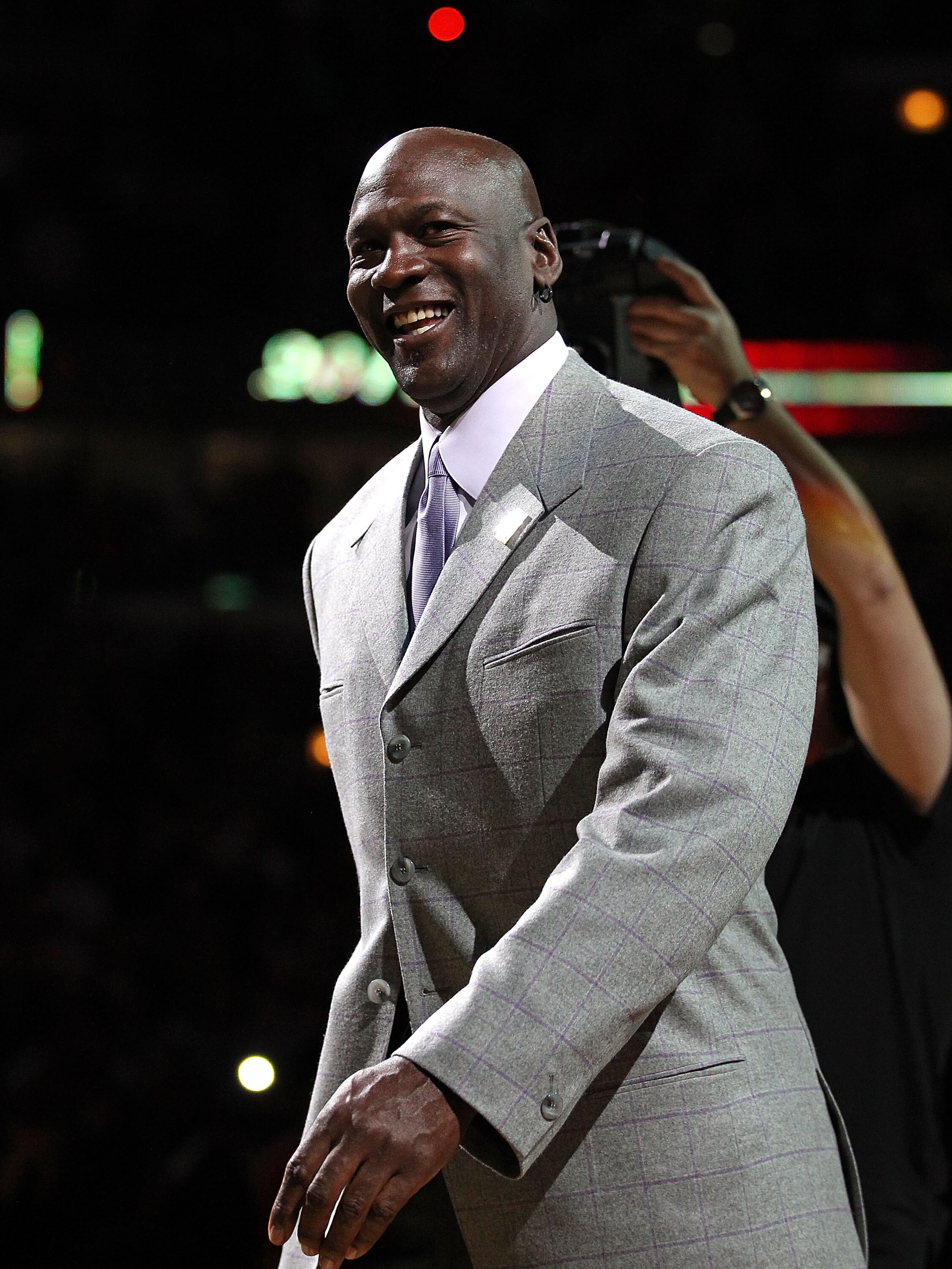 CHICAGO, IL - MARCH 12: Former player Michael Jordan of the Chicago Bulls smiles as he is introduced to  the crowd during a 20th anniversary recognition ceremony of the Bulls 1st NBA Championship in 1991 during half-time of a game bewteen the Bulls and th