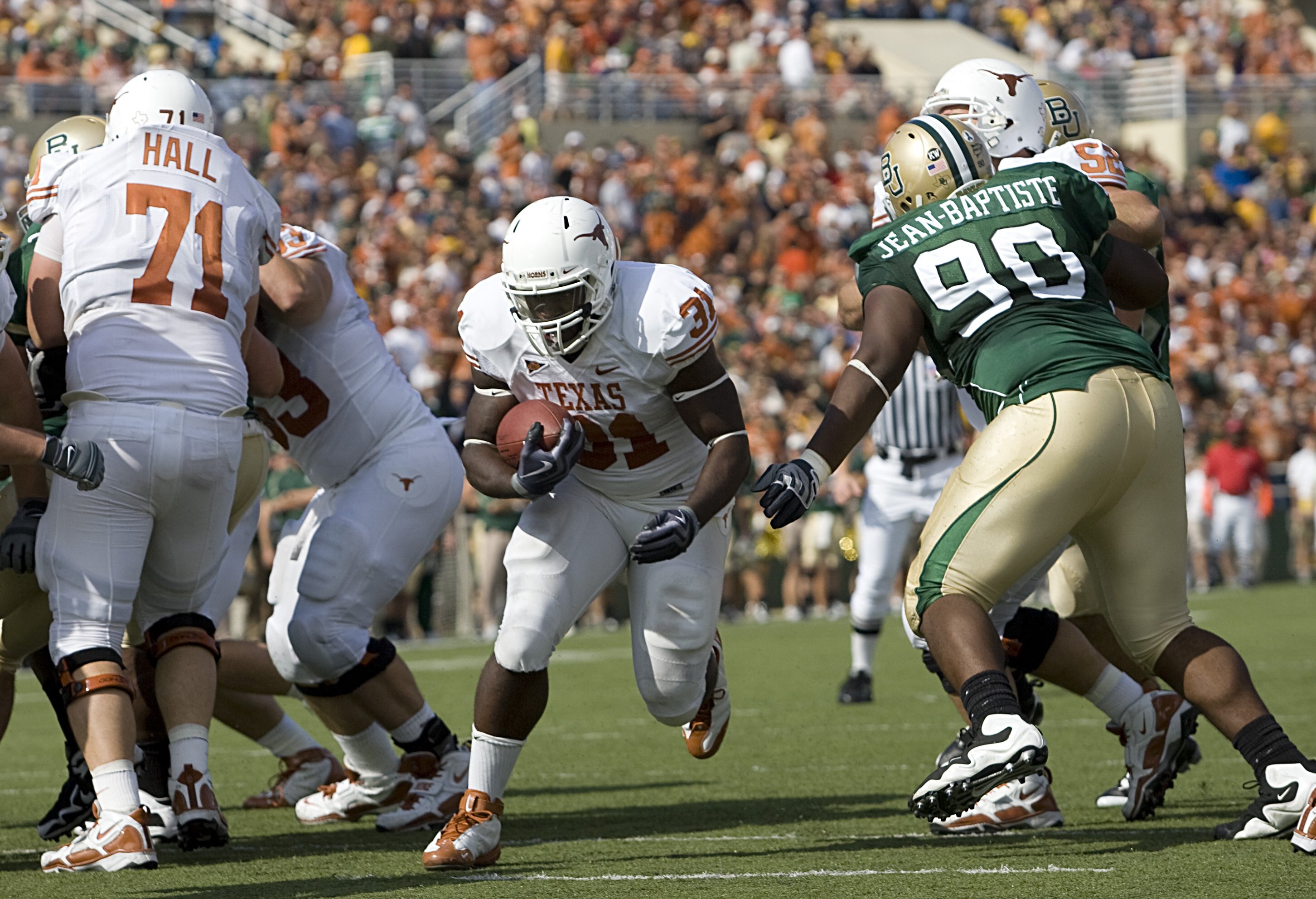 WACO, TX - NOVEMBER 14:  Running back Cody Johnson #31 of the Texas Longhorns carries the ball into the end zone during the first half against tackle Nicolas Jean-Baptiste #90 of the Baylor Bears on November 14, 2009 at Floyd Casey Stadium in Waco, Texas.