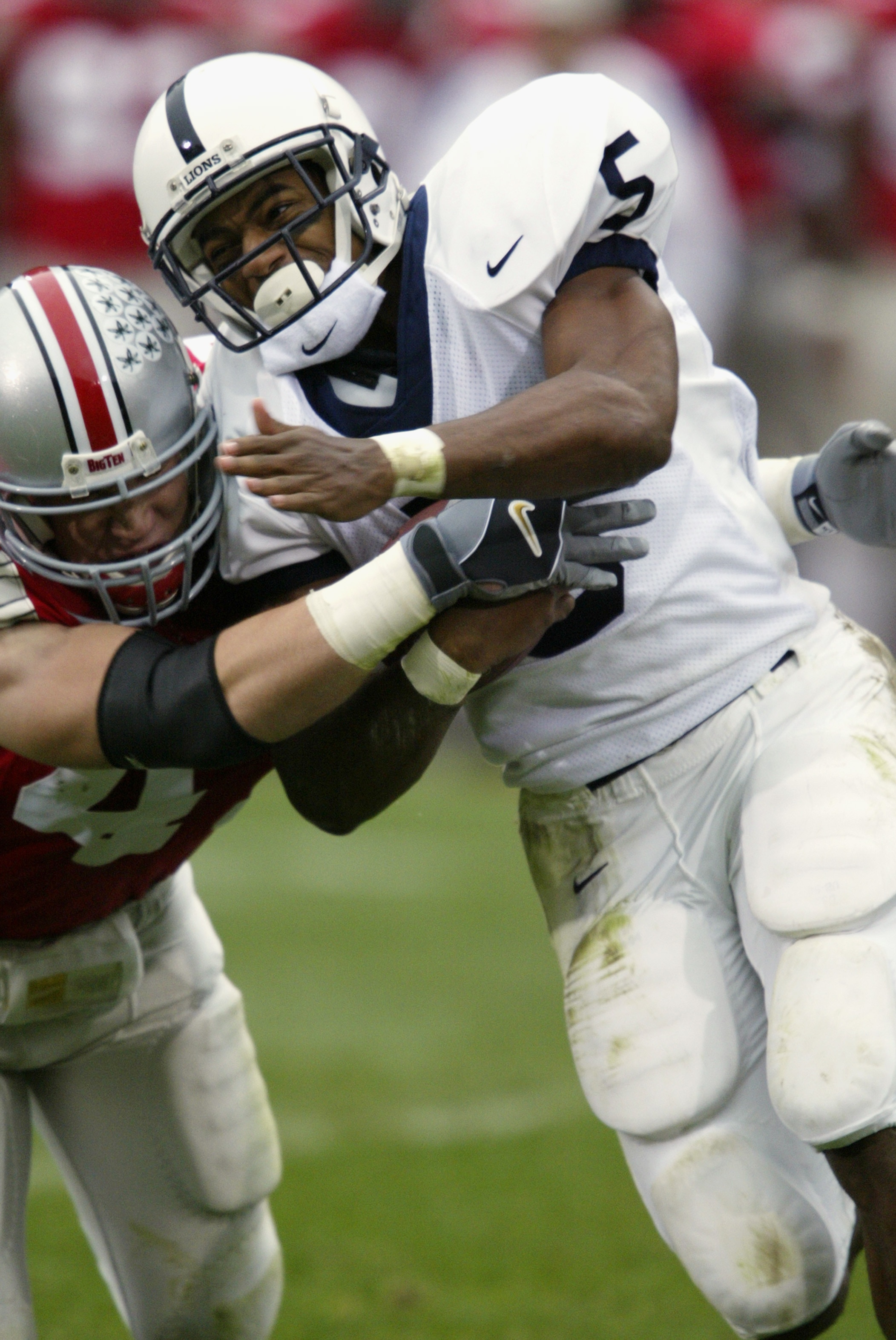 COLUMBUS - OCTOBER 26:  Penn State tailback Larry Johnson #5 is tackled during the NCAA football game against Ohio State at Ohio Stadium on October 26, 2002 in Columbus, Ohio.  The Ohio State Buckeyes defeated the Penn State Nittany Lions in a closely fou