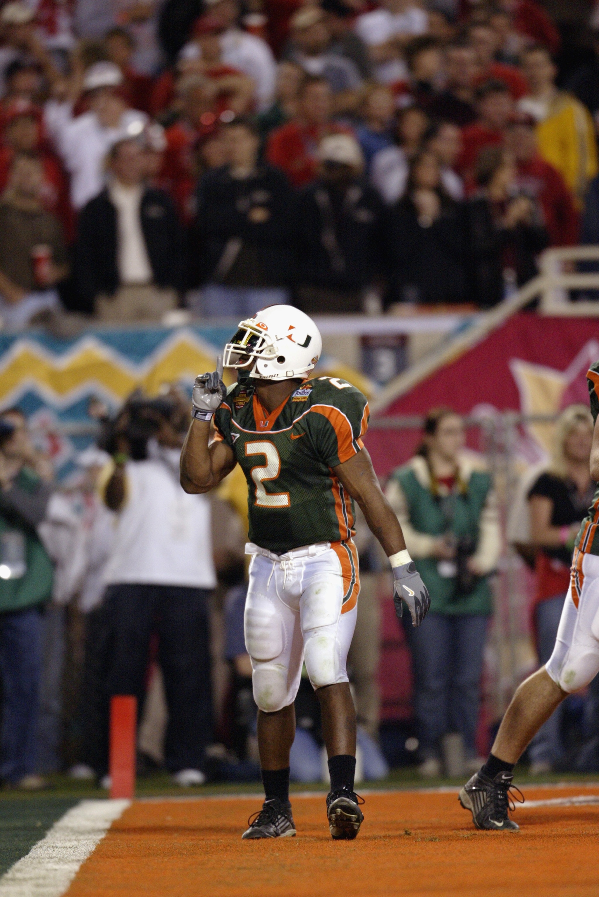 TEMPE, AZ - JANUARY 3:  Running back Willis McGahee #2 of the University of Miami Hurricanes quiets the Ohio State Buckeyes fans after scoring the team's second touchdown during the Tostitos Fiesta Bowl at Sun Devil Stadium on January 3, 2003 in Tempe, Ar