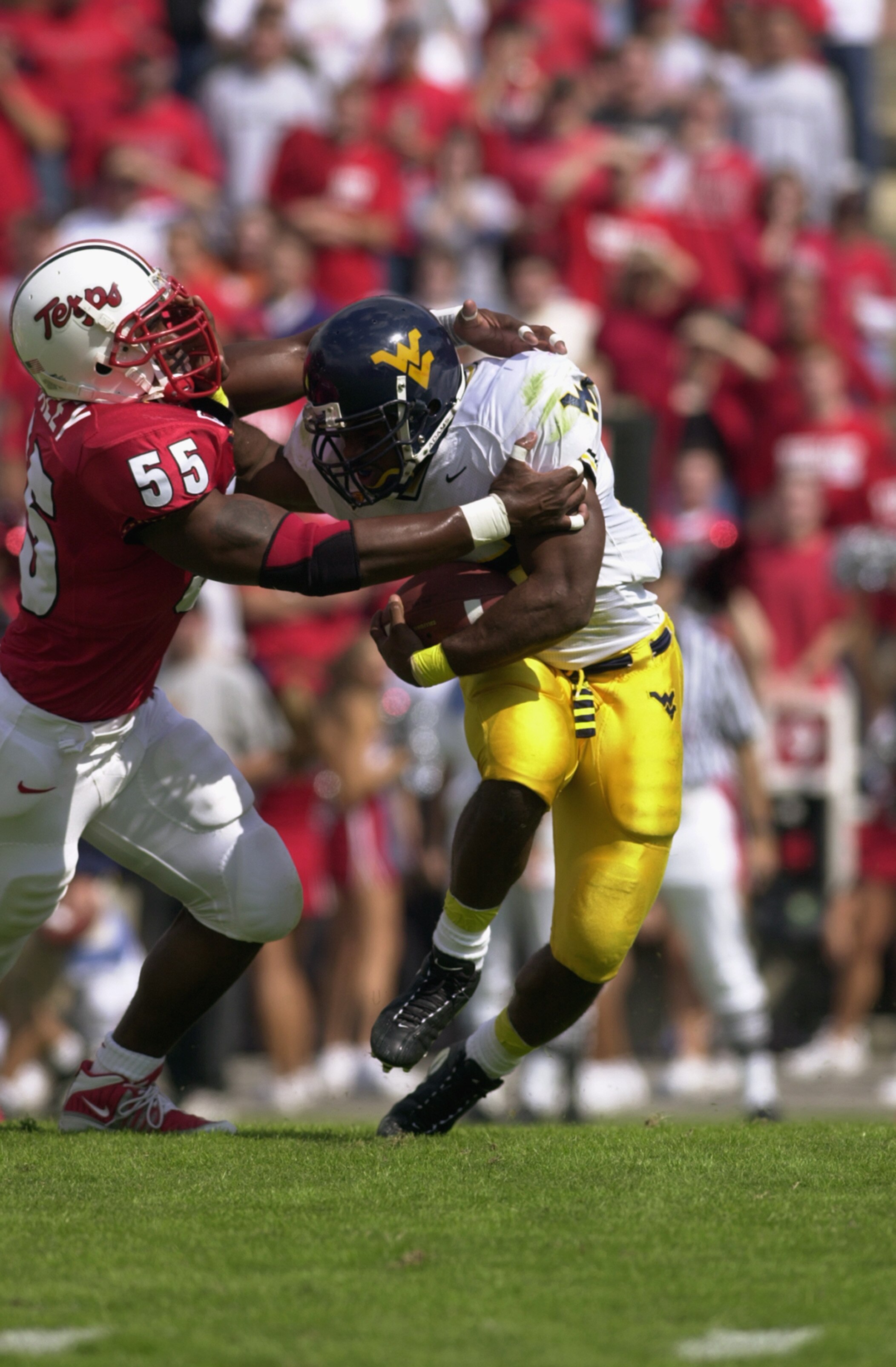 COLLEGE PARK, MD - SEPTEMBER 29:  Running Back Avon Cobourne #22 of the West Virginia Mouintaineers is tackled for a loss of yardage by linebacker Mike Whaley #55 of the Maryland Terrapins during the game on September 29, 2001 at the Byrd Stadium in Colle