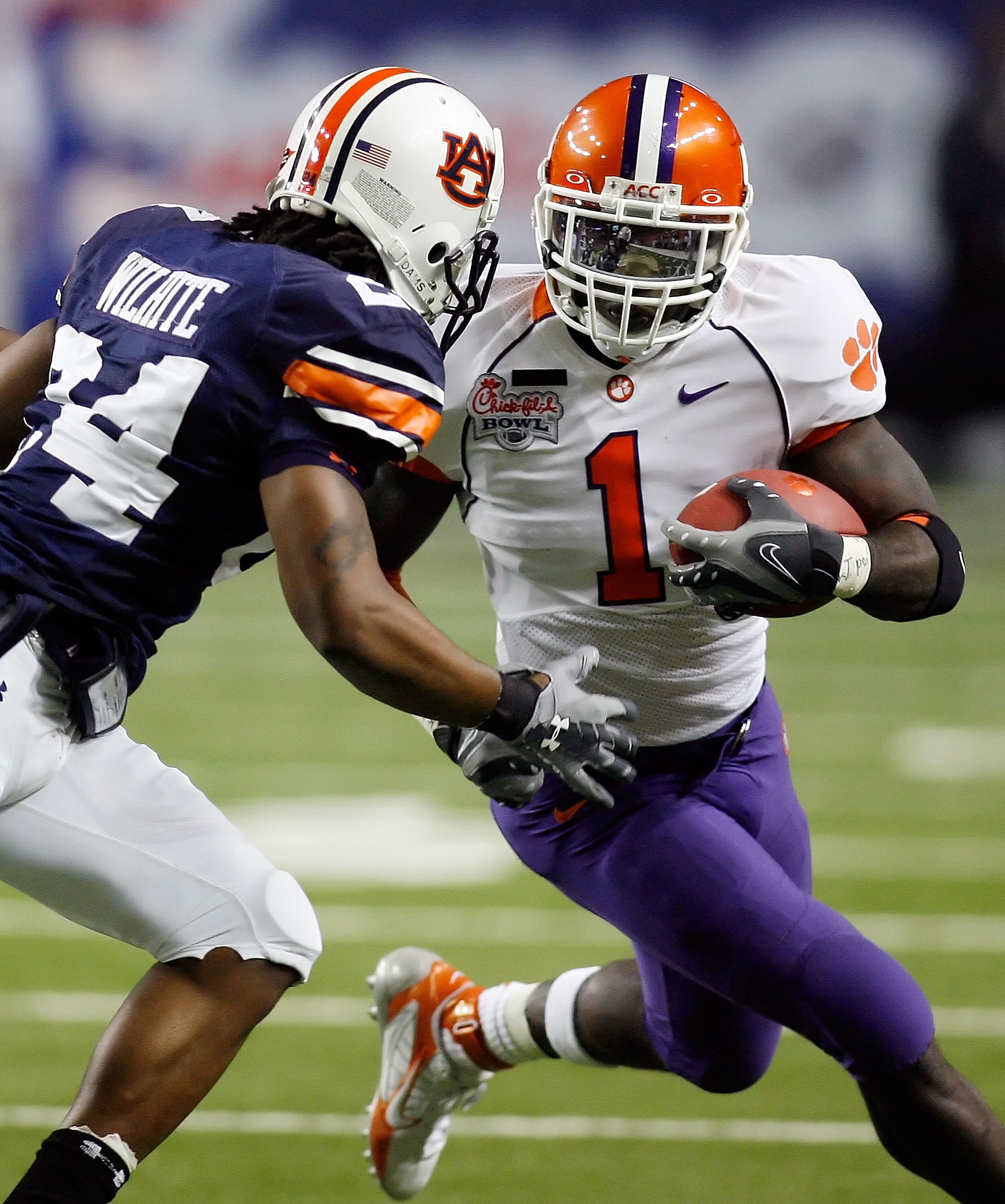ATLANTA - DECEMBER 31: James Davis #1 of the Clemson Univeristy Tigers runs around Jonathan Wilhite #24 of the Auburn University Tigers during the Chick-Fil-A Bowl on December 31, 2007 at the Georgia Dome in Atlanta, Georgia.  (Photo by Chris Graythen/Get