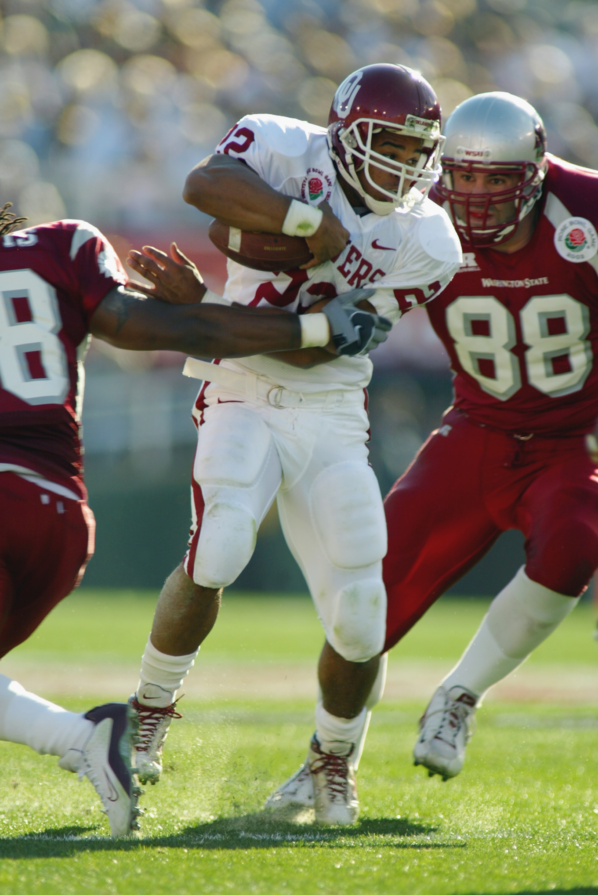 PASADENA, CA - JANUARY 1:  Running back Quentin Griffin #22 of the Oklahoma Sooners is caught by WSU Cougars defense during the 89th Rose Bowl on January 1, 2003 at the Rose Bowl in Pasadena, California.  The University of Oklahoma Sooners defeated the Wa
