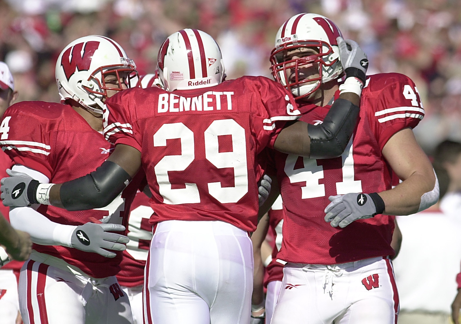 21 Oct 2000: Michael Bennett #29 of Wisconsin is congratulated by teammates Eddie Faulkner #4 and Chad Kuhns #41 after Bennett ran the ball in for a touchdown against Purdue during the second quarter at Camp Randall Stadium in Madison, Wisconsin. DIGITAL