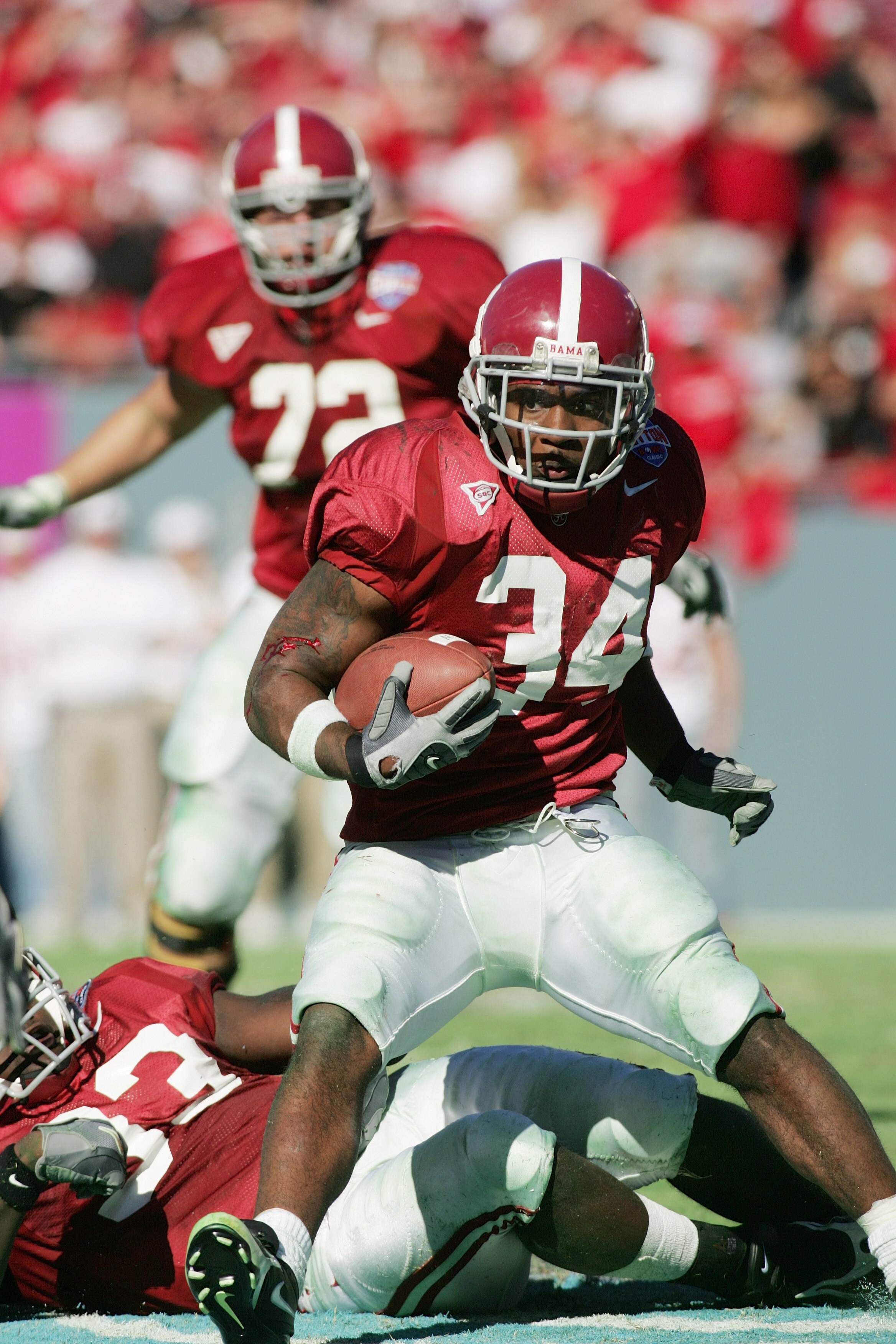 DALLAS - JANUARY 2:  Running back Kenneth Darby #34 of the Alabama Crimson Tide carries the ball against the Texas Tech Red Raiders during the AT&T Cotton Bowl on January 2, 2006 in Dallas, Texas.  The Crimson Tide defeated the Red Raiders 13-10.  (Photo