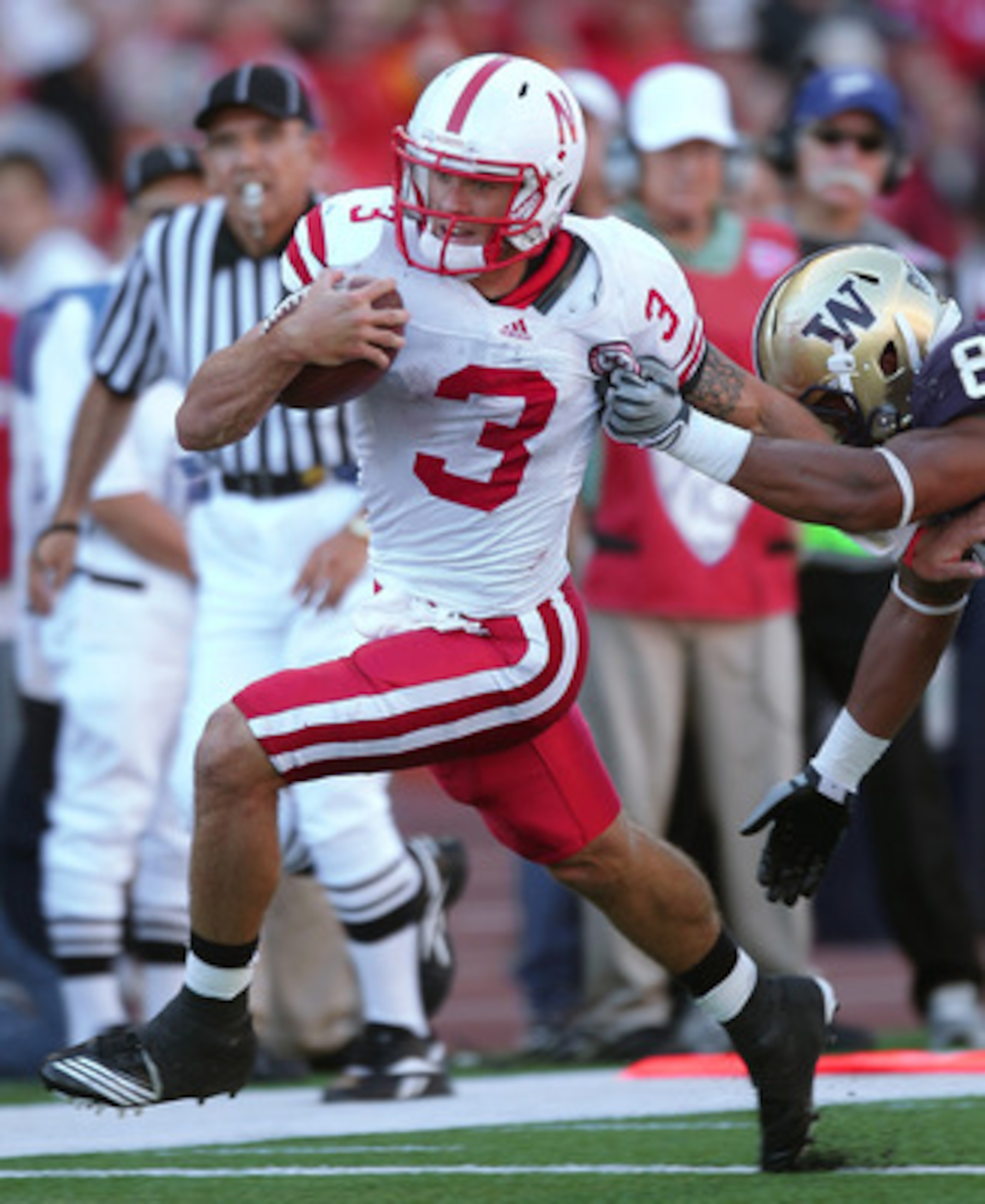 SEATTLE - SEPTEMBER 18:  Quarterback Taylor Martinez #3 of the Nebraska Cornhuskers rushes against Nate Williams #8 of the Washington Huskies on September 18, 2010 at Husky Stadium in Seattle, Washington. The Cornhuskers defeated the Huskies 56-21. (Photo