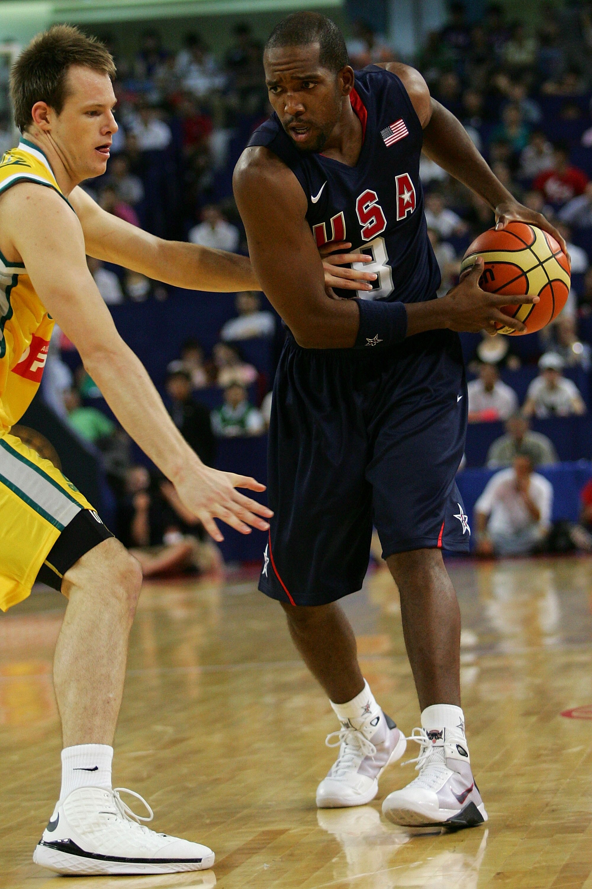SHANGHAI, CHINA - AUGUST 05:  Michael Redd #8 of the USA Basketball Men's Senior National Team holds a ball against Brad Newley #8 of the Australia National Team during the USA Basketball International Challenge exhibition game at the Qizhong Arena on Aug