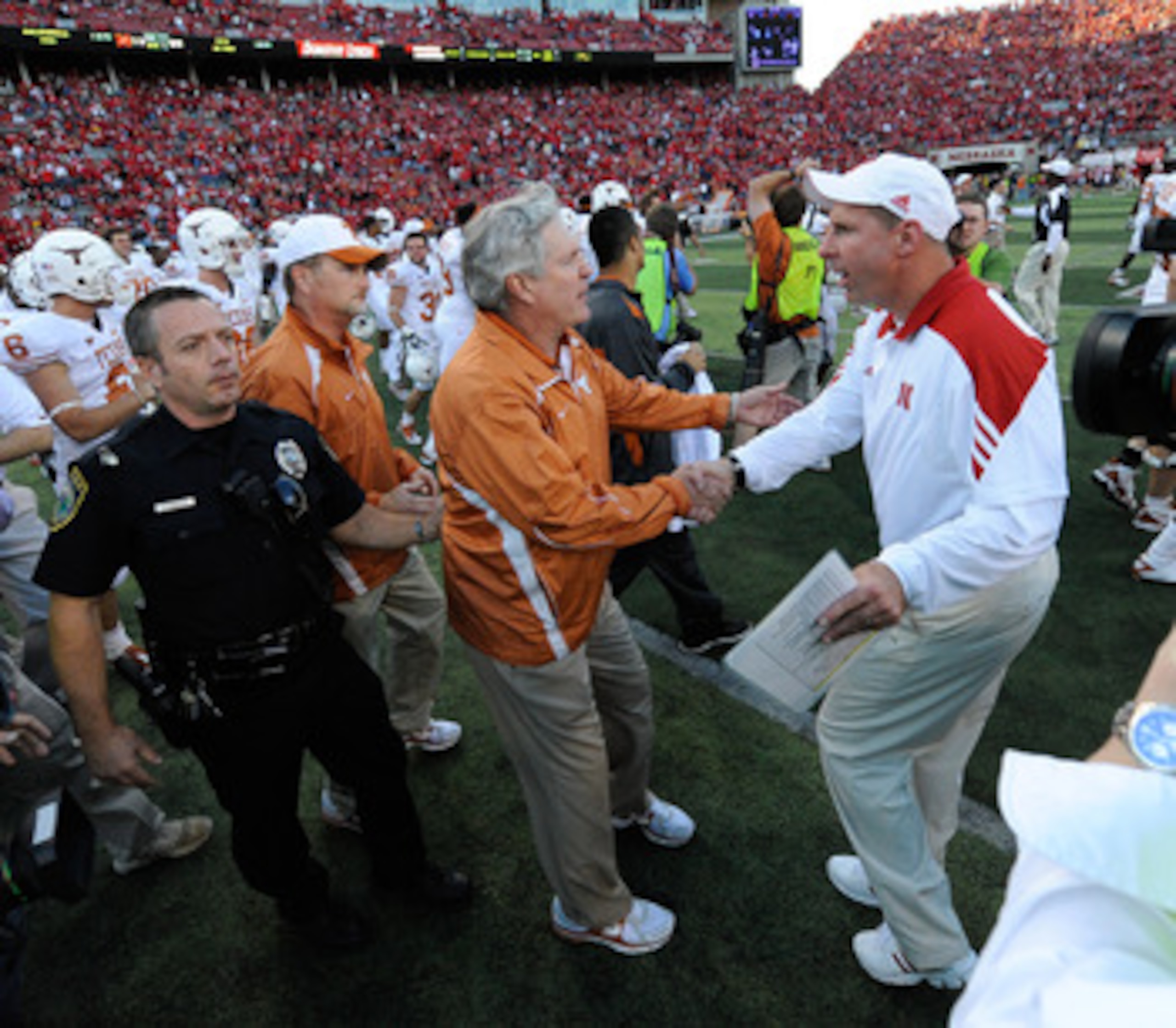 LINCOLN, NE - OCTOBER 16: Coach Mack Brown (left) of the Texas Longhorns shakes hands with Coach Bo Pelini of the Nebraska Cornhuskers after their game at Memorial Stadium on October 16, 2010 in Lincoln, Nebraska. Texas Defeated Nebraska 20-13. (Photo by 