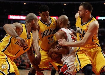 CHICAGO, IL - APRIL 26: Taj Gibson #22 of the Chicago Bulls battles for the ball with (L-R) Dahntay Jones #1, Danny Granger #33 and Josh McRoberts #32 of the Indiana Pacers in Game Five of the Eastern Conference Quarterfinals in the 2011 NBA Playoffs at t