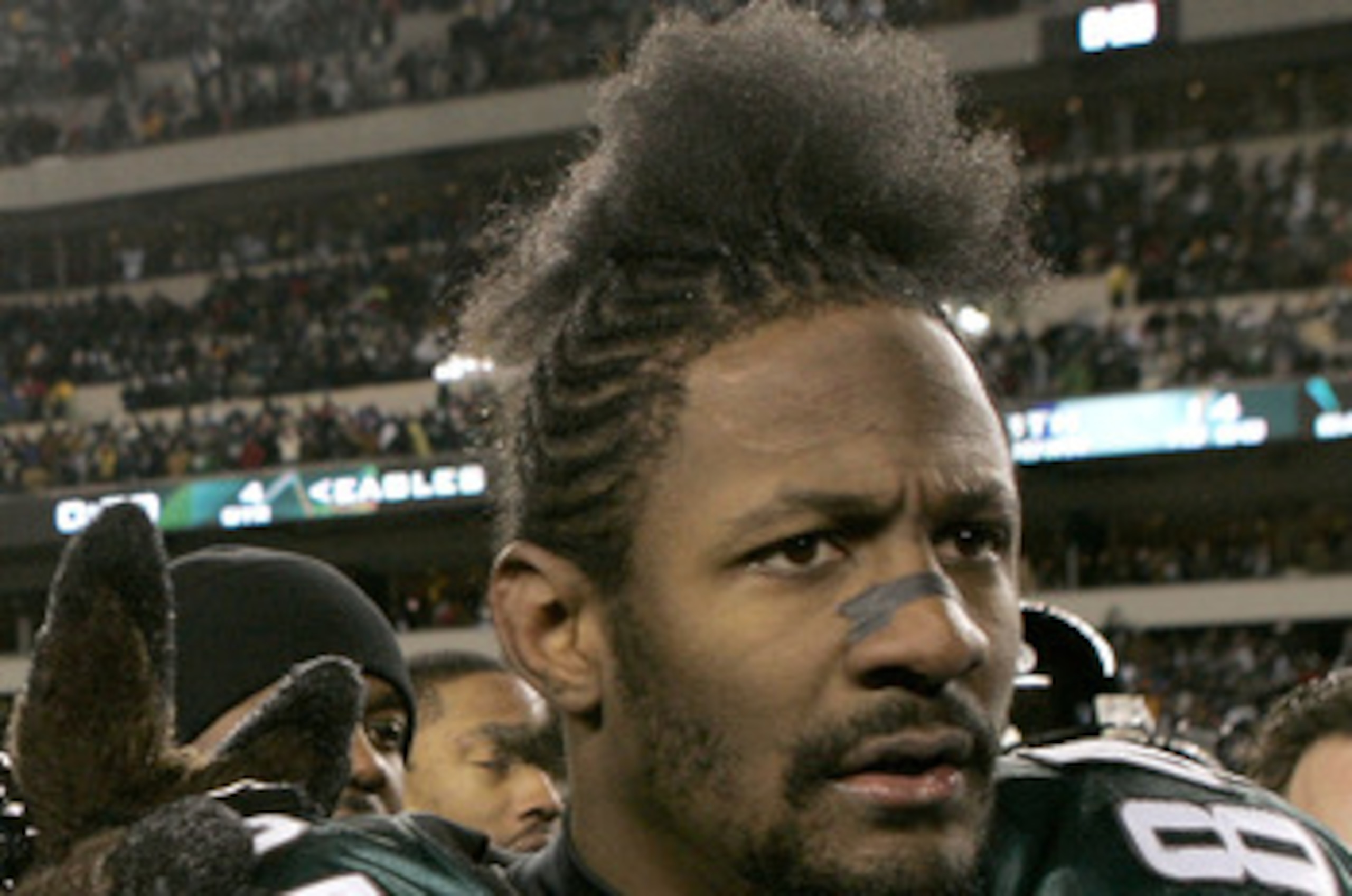 PHILADELPHIA - JANUARY 23:  The Philadelphia Eagles mascot walks with wide receiver Freddie Mitchell #84 after the Eagles won the NFC Championship game over the Atlanta Falcons at Lincoln Financial Field on January 23, 2005 in Philadelphia, Pennsylvannia.
