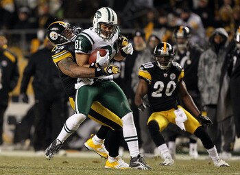 PITTSBURGH, PA - JANUARY 23:  Dustin Keller #81 of the New York Jets makes a reception against LaMarr Woodley #56 of the Pittsburgh Steelers during the 2011 AFC Championship game at Heinz Field on January 23, 2011 in Pittsburgh, Pennsylvania. The Steelers
