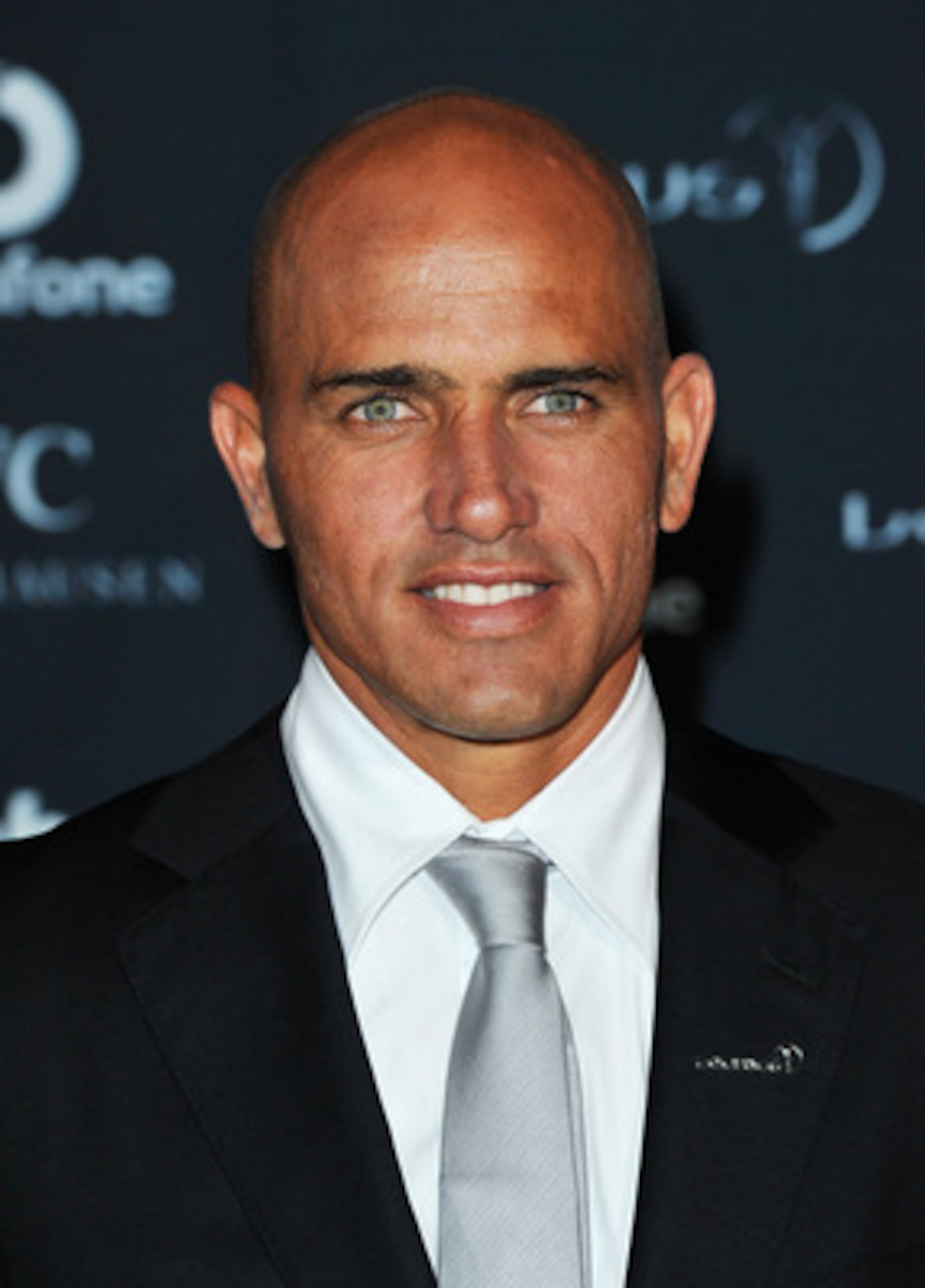 ABU DHABI, UNITED ARAB EMIRATES - FEBRUARY 07:  Surfer Kelly Slater of the United States poses with his award for ÂLaureus World Action Sportsperson of the YearÂ in the winners studio at the 2011 Laureus World Sports Awards at the Emirates Palace on Febru