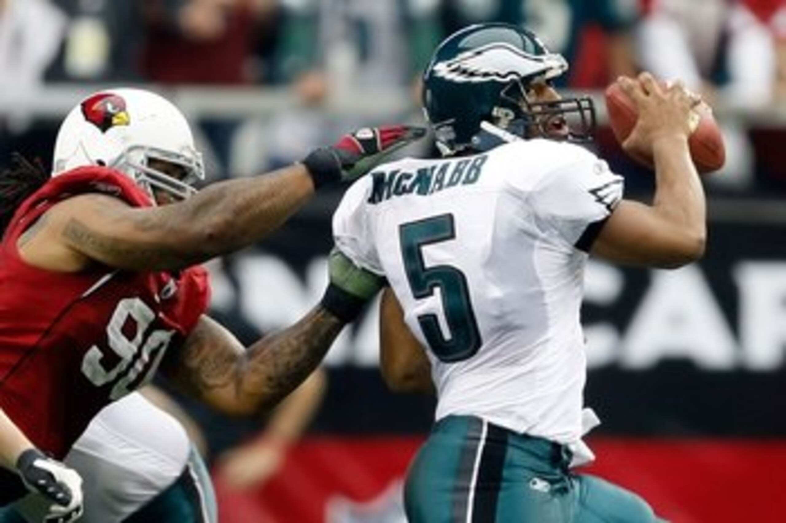 GLENDALE, AZ - JANUARY 18:  Quarterback Donovan McNabb #5 of the Philadelphia Eagles looks to avoid a sack from defensive end Darnell Dockett #90 of the Arizona Cardnals during the NFC championship game on January 18, 2009 at University of Phoenix Stadium