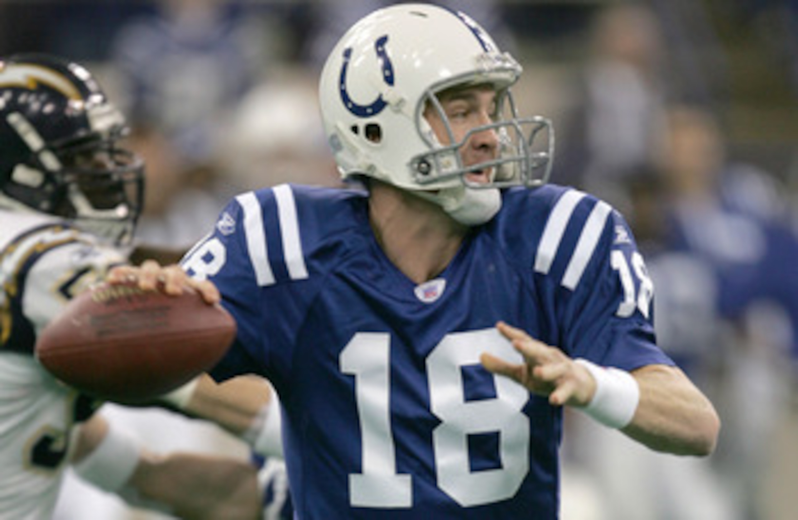 INDIANAPOLIS - DECEMBER 26:  Quarterback Peyton Manning #18 of the Indianapolis Colts snaps back to pass during a game against the San Diego Chargers at the RCA Dome in Indianapolis, Indiana. The Colts defeated the Chargers 34-31 in overtime.  (Photo by J